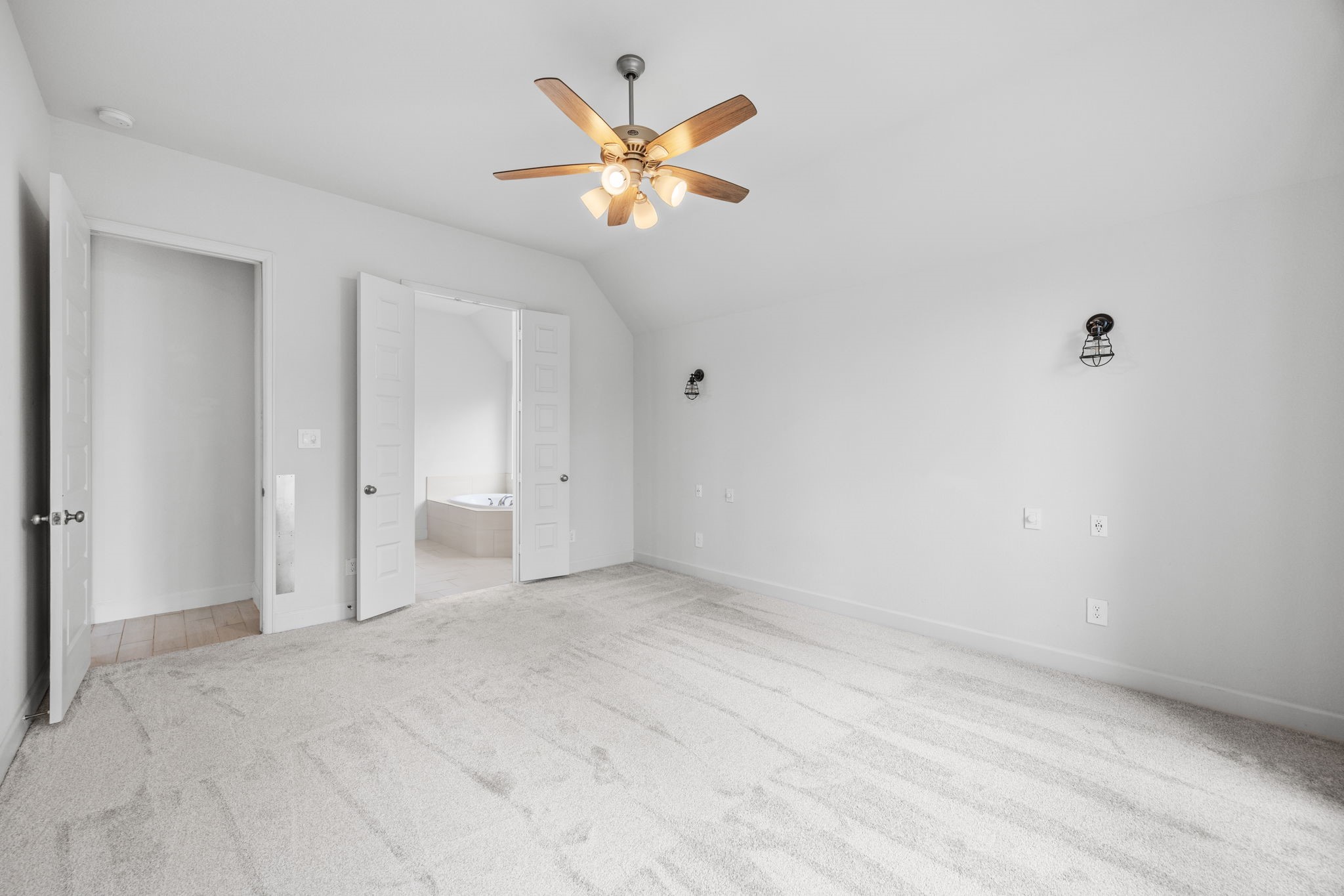 Light and airy bedroom with neutral finishes and flexible space for your furnishings.