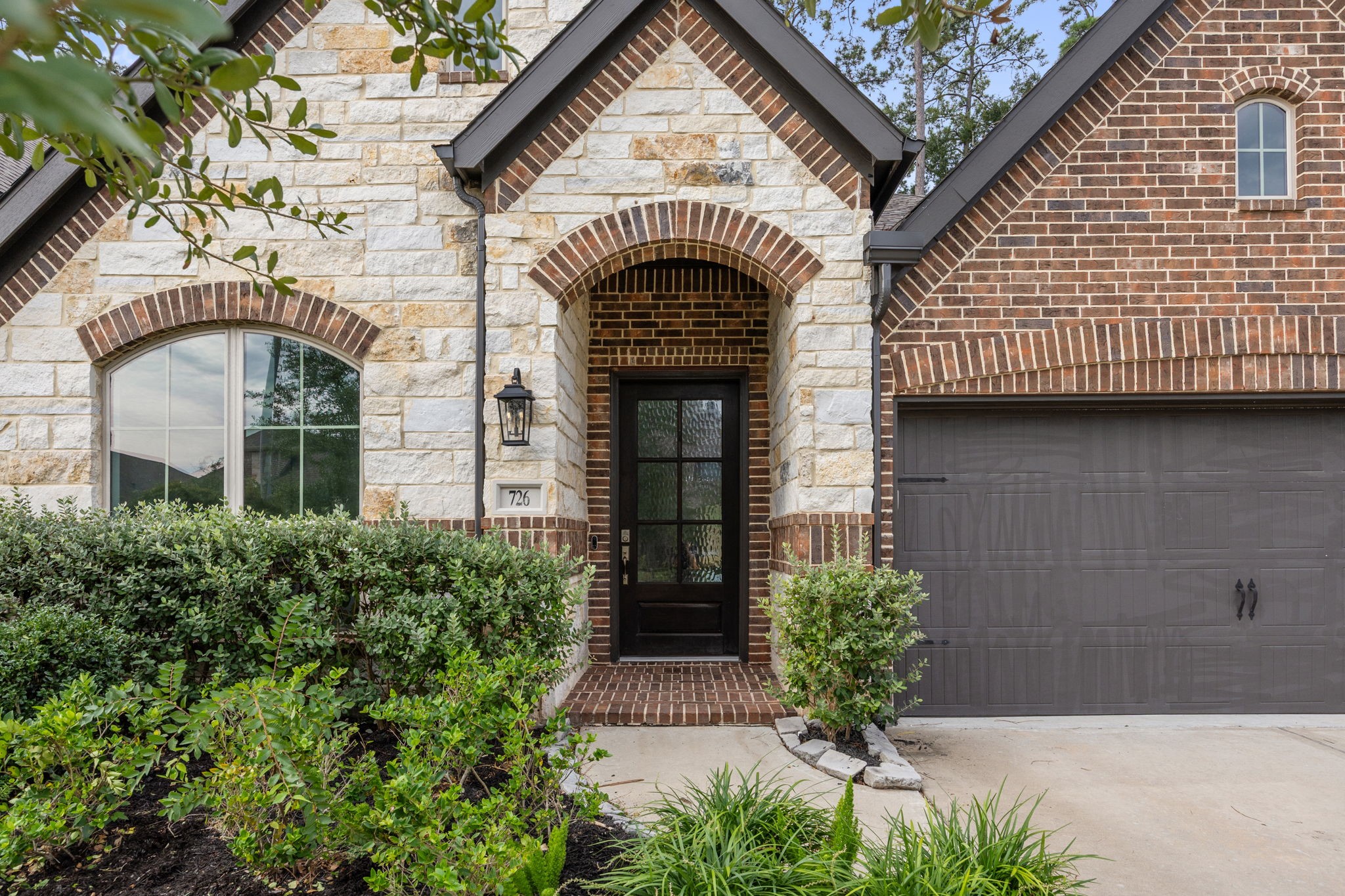 Timeless brick and stone exterior with charming architectural details and a welcoming covered entry.