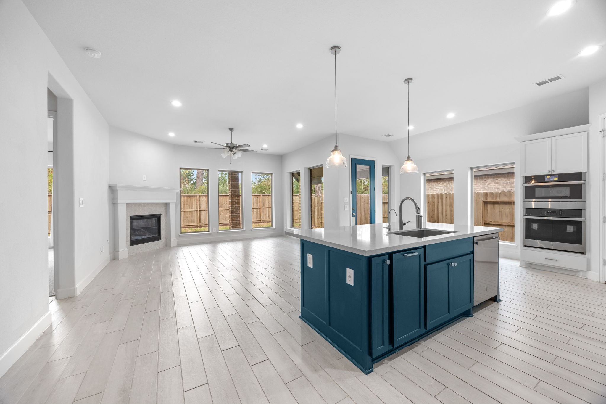 Spacious chef-inspired kitchen with an oversized island, abundant cabinetry, and stylish pendant lighting.