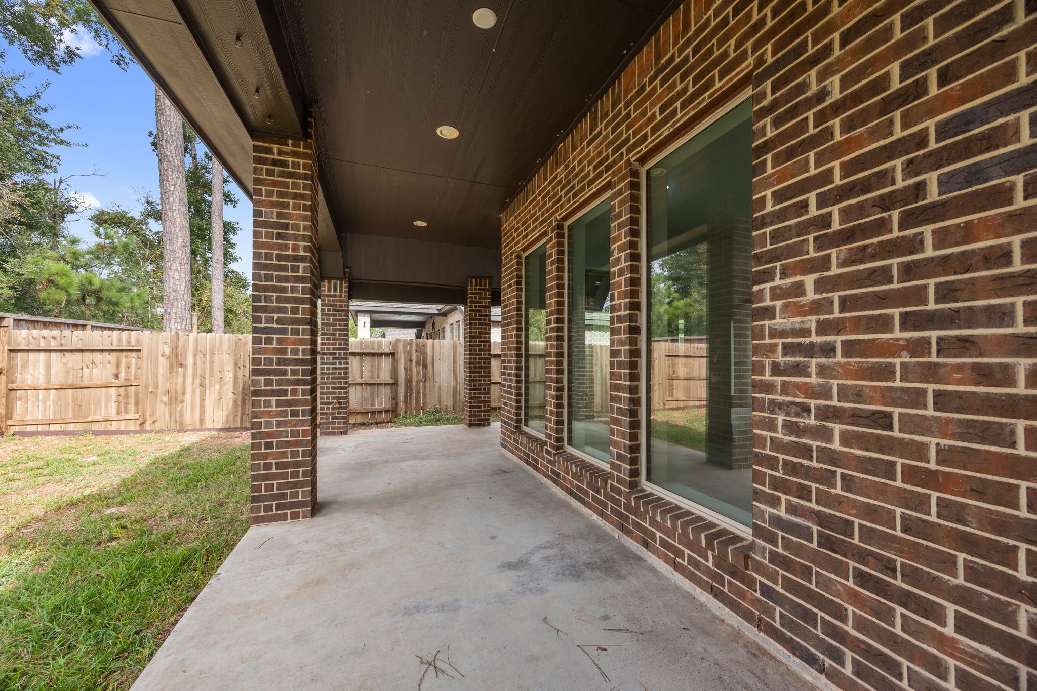 Extended covered patio provides a shaded setting for relaxing, dining, and enjoying the backyard year-round.