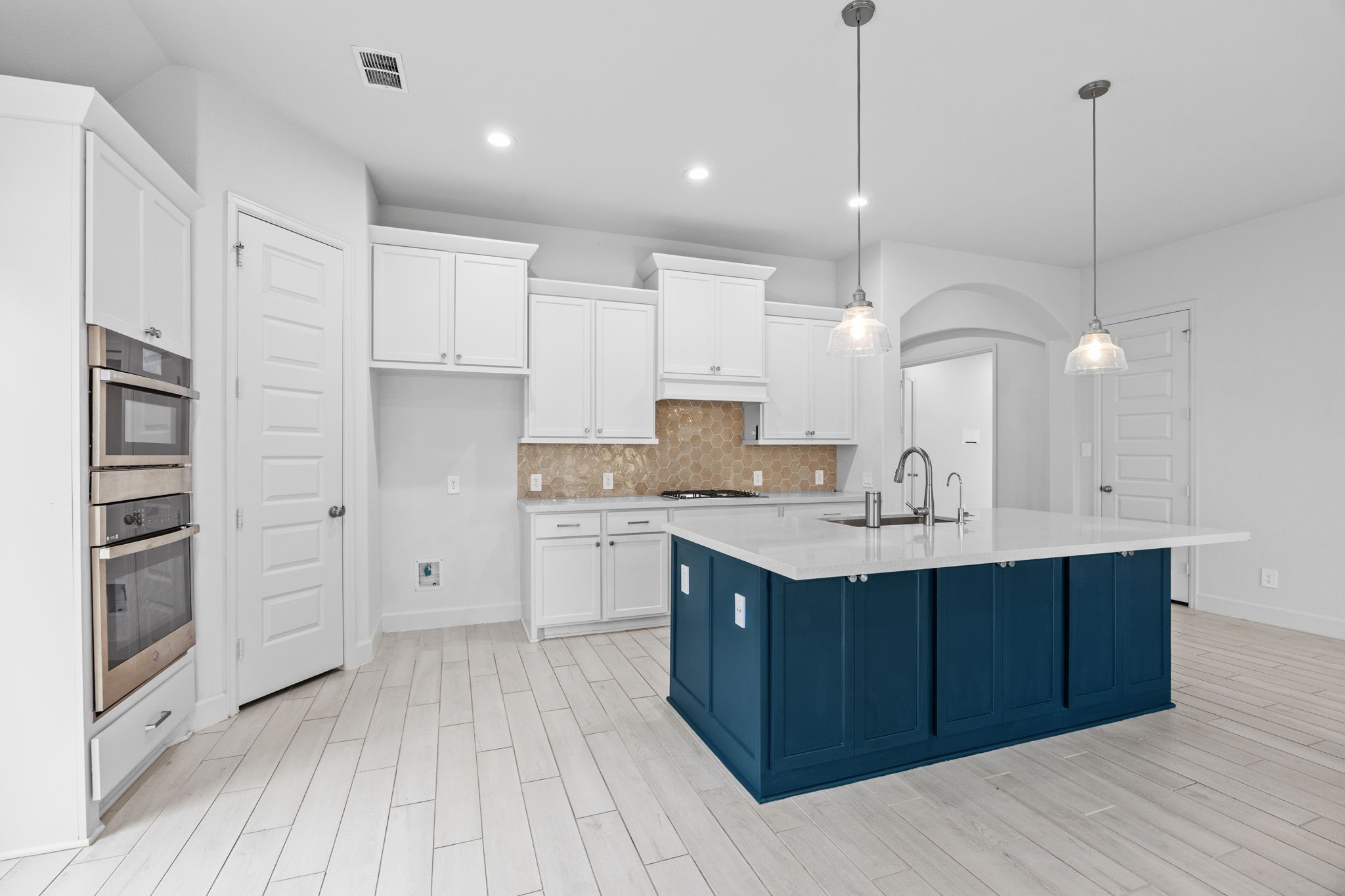 A spacious kitchen with a large center island that serves as the heart of the home.
