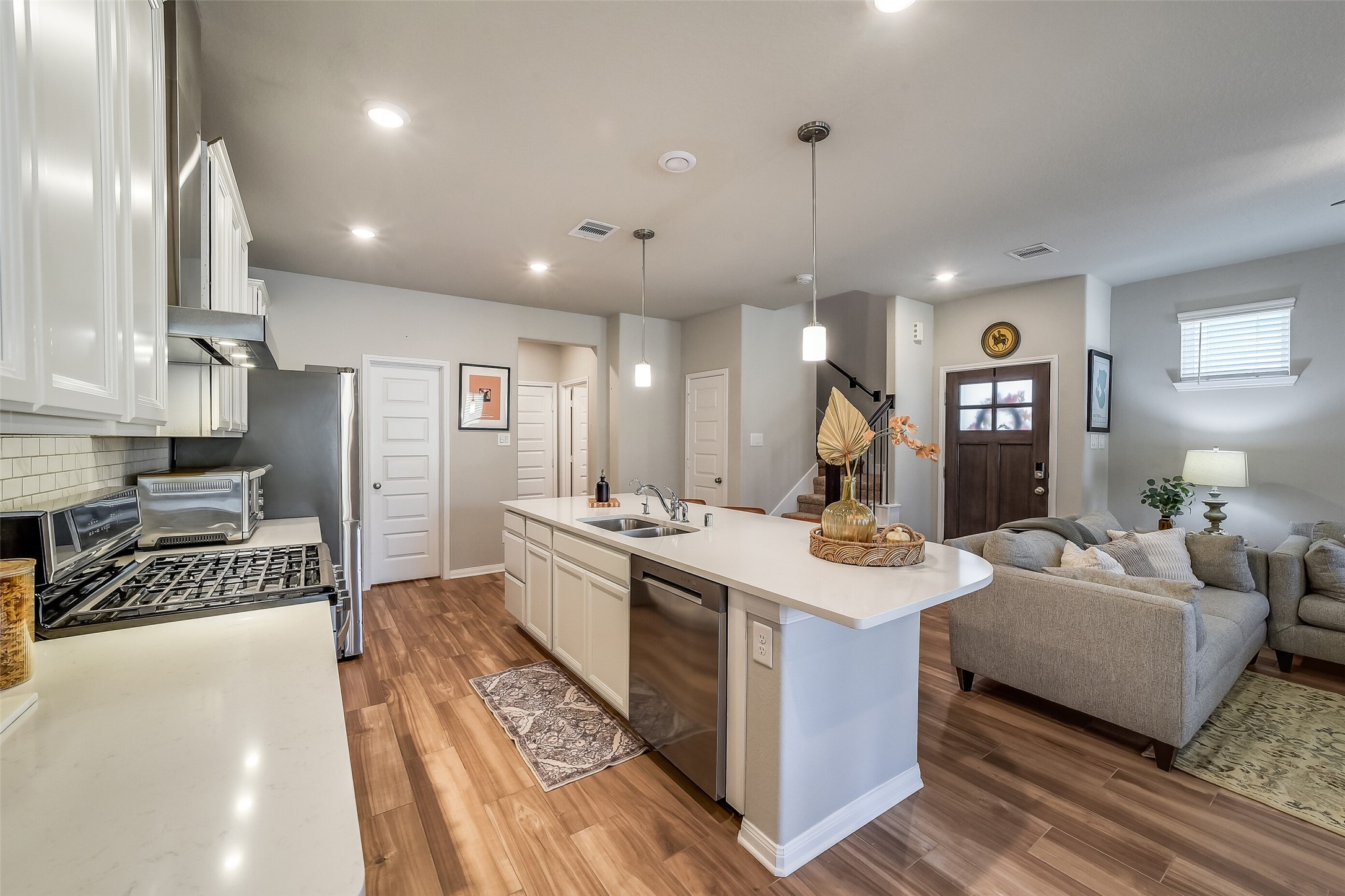 Prepare meals while staying part of the conversation, with the island overlooking the living room and offering convenient seating for guests. Prepare meals while staying part of the conversation, with the island overlooking the living room and offering convenient seating for guests.
