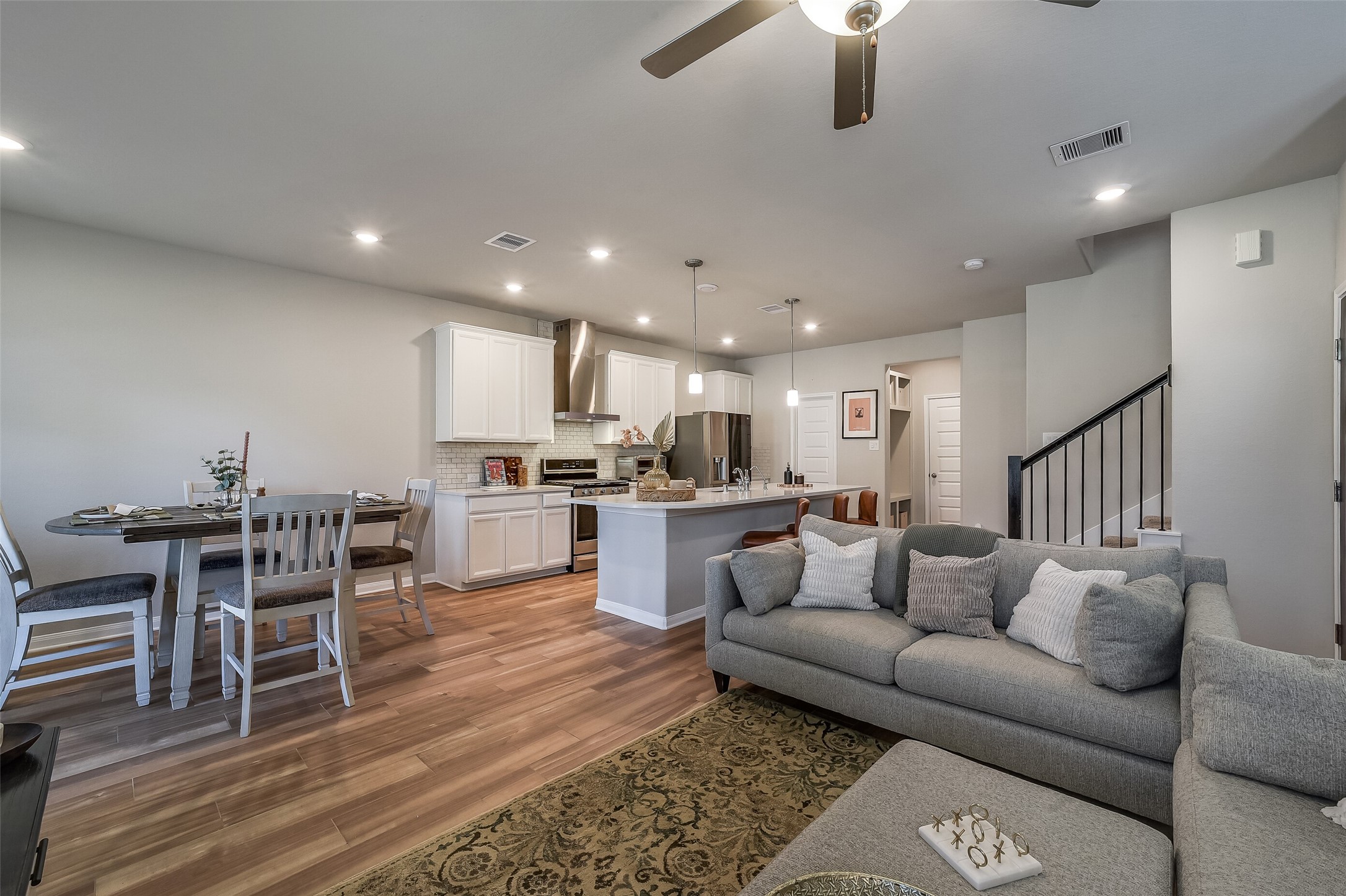 An open layout lets you stay connected while cooking, dining, or relaxing, with continuous wood-look flooring tying the spaces together. An open layout lets you stay connected while cooking, dining, or relaxing, with continuous wood-look flooring tying the spaces together.