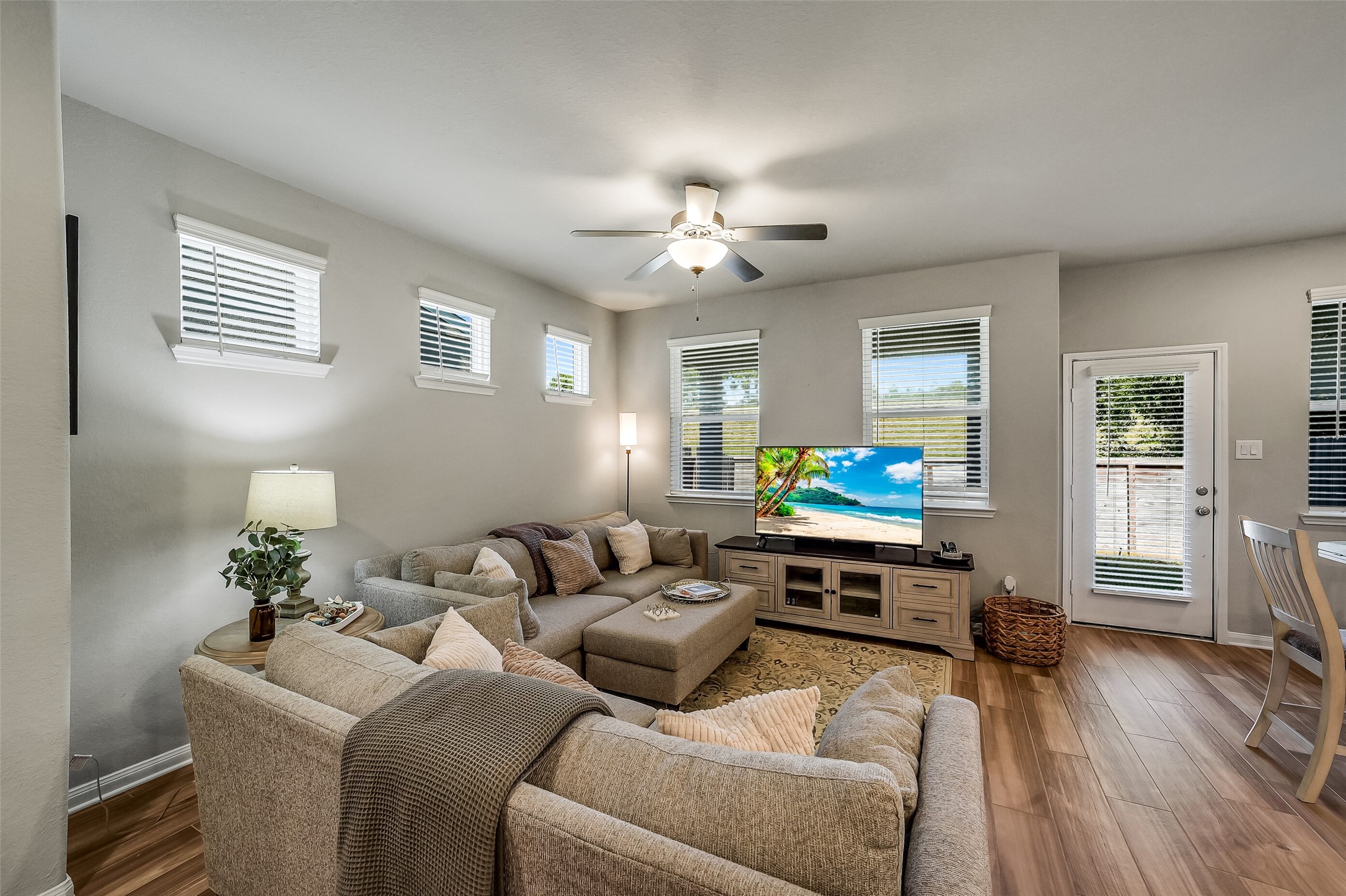 Settle in for a quiet evening or gather with friends in this comfortable living room, featuring windows on multiple walls and a ceiling fan.Settle in for a quiet evening or gather with friends in this comfortable living room, featuring windows on multiple walls and a ceiling fan. Settle in for a quiet evening or gather with friends in this comfortable living room, featuring windows on multiple walls and a ceiling fan.Settle in for a quiet evening or gather with friends in this comfortable living room, featuring windows on multiple walls and a ceiling fan.