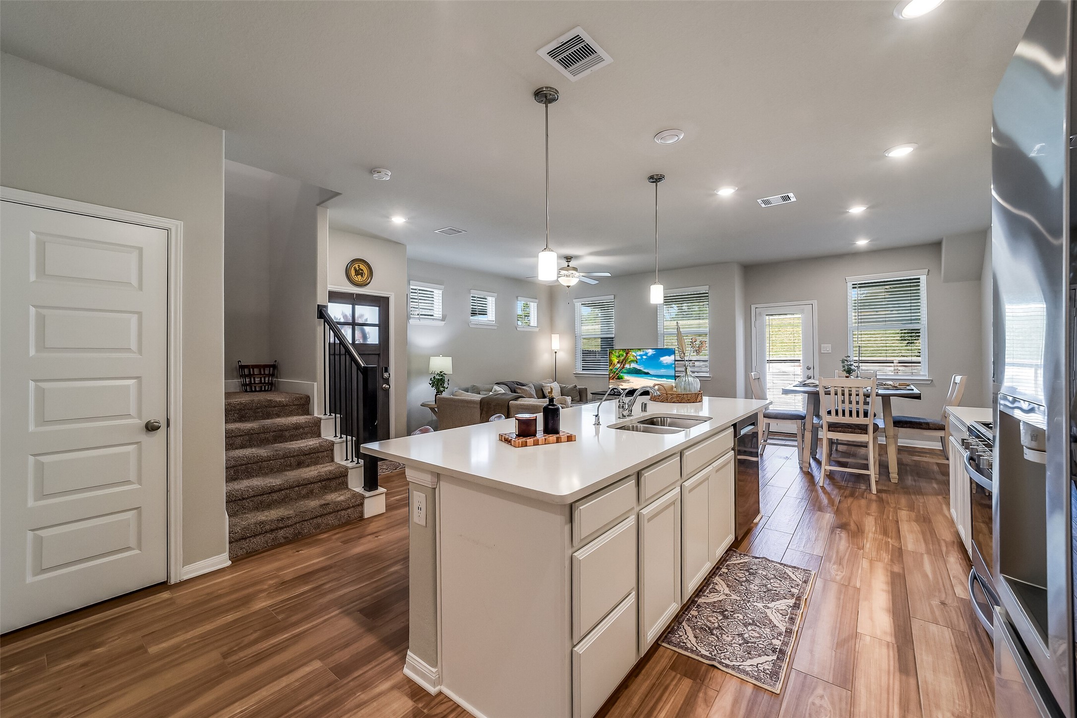 Island drawers and cabinetry offer convenient kitchen storage, while the open layout provides a natural connection to the rest of the main floor.
