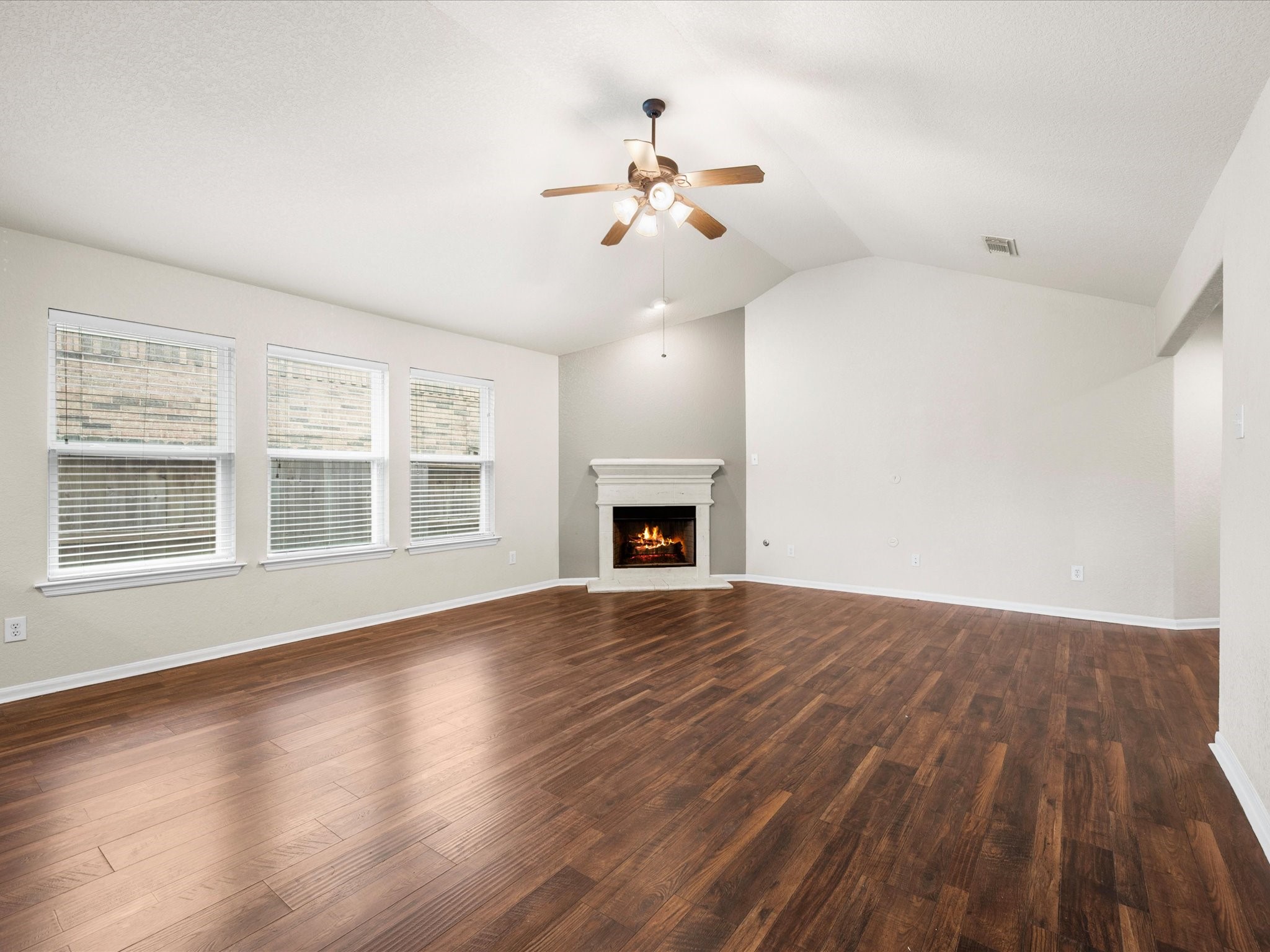 Sunlit windows fill the spacious family room with warmth while creating an inviting atmosphere for everyday living and entertaining.