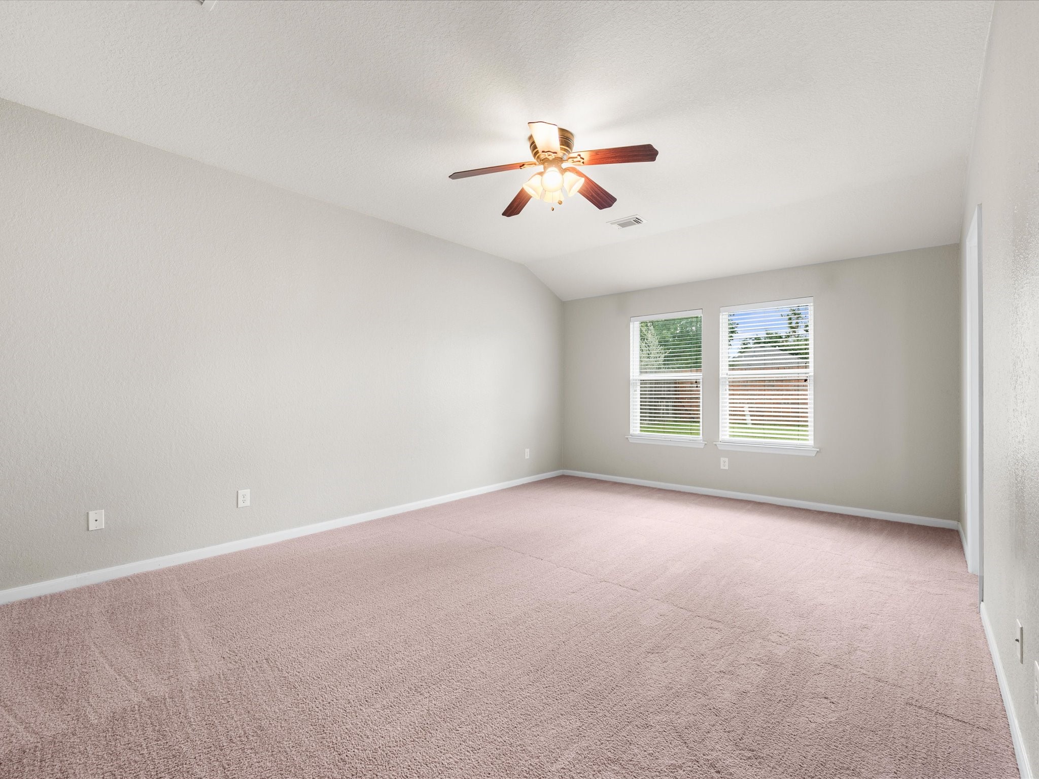 The spacious primary suite offers a peaceful retreat with room to relax and unwind at the end of the day.