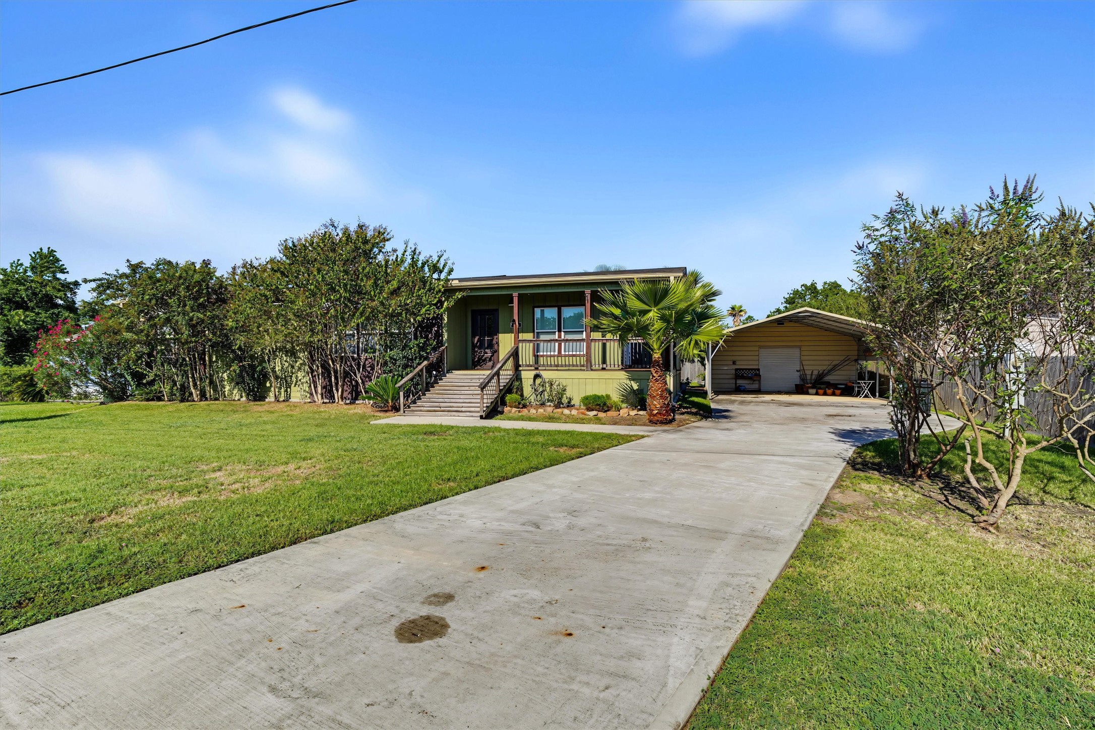 The long driveway provides parking for a lot of vehicles. The front porch is a nice place to sit and relax
