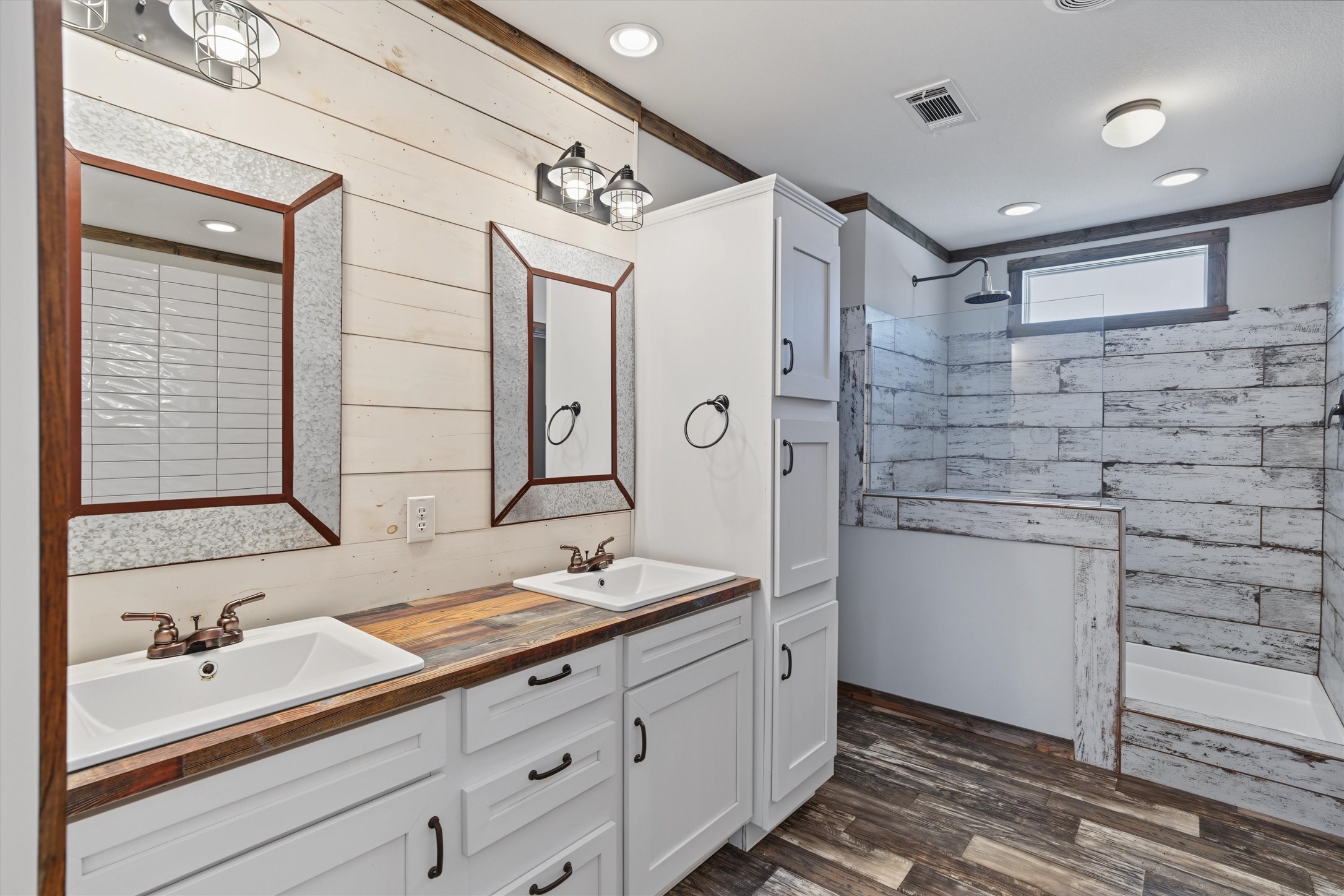 Spa-Like Primary Ensuite  A beautifully appointed primary bathroom featuring dual sinks and an oversized walk-in shower, creating a spacious and relaxing retreat with plenty of storage
