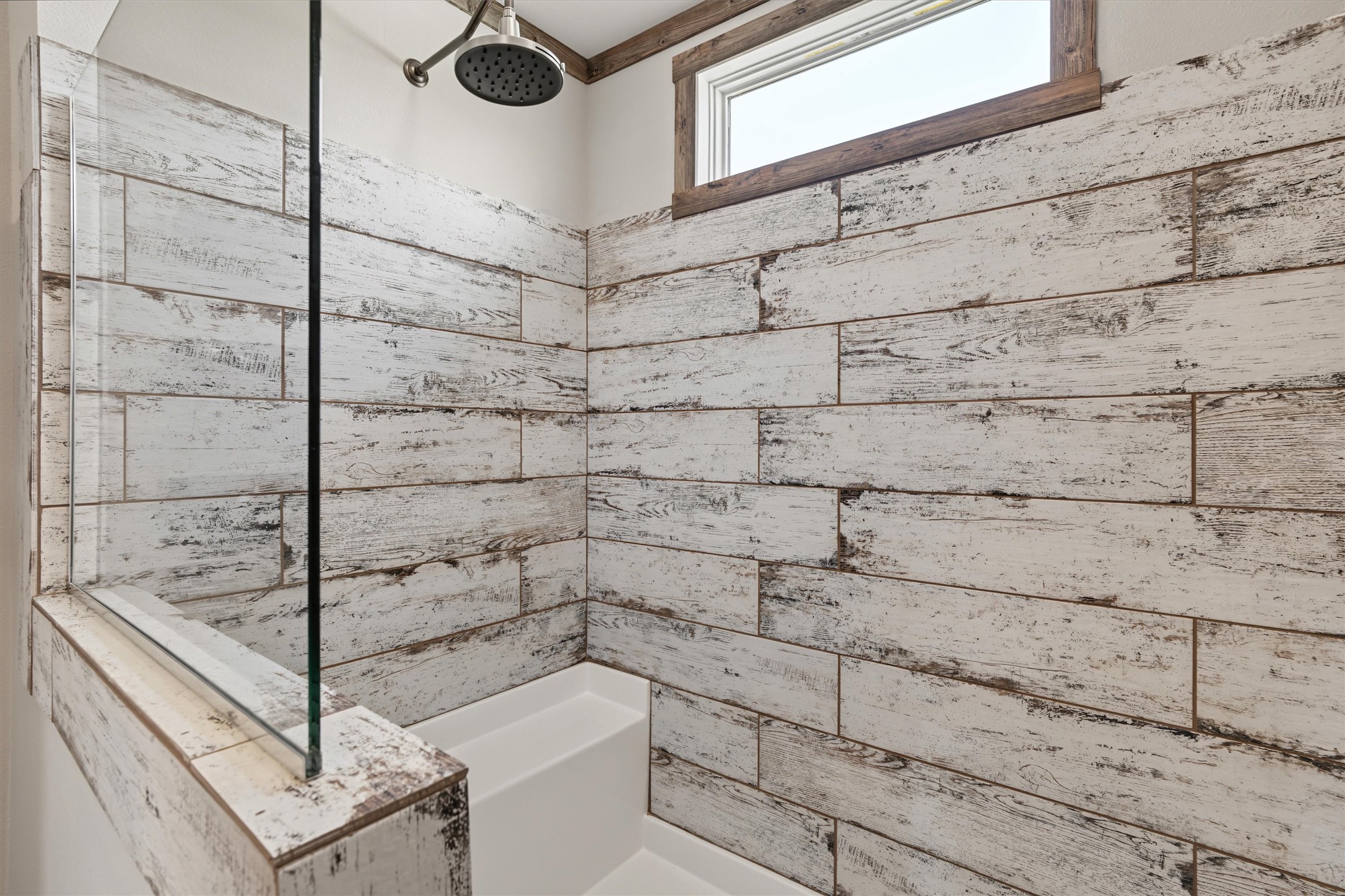 Beautifully Tiled Walk-In Shower  An oversized walk-in shower with stylish tilework offers a spacious, modern, and inviting space to start and end your day