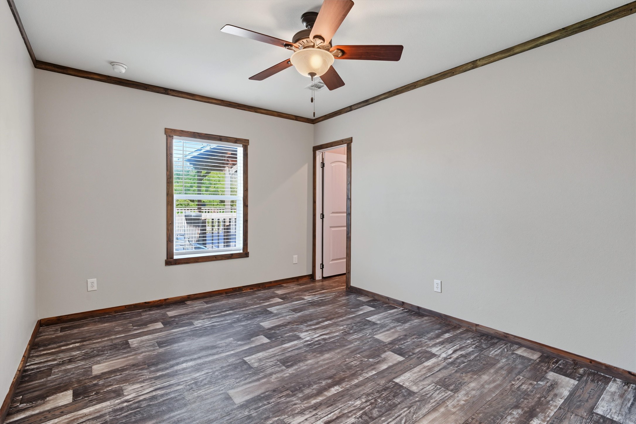 Spacious Bedroom with Walk-In Closet  A generously sized bedroom offering plenty of room for comfortable furnishings, natural light, and the convenience of a large walk-in closet for exceptional storage.