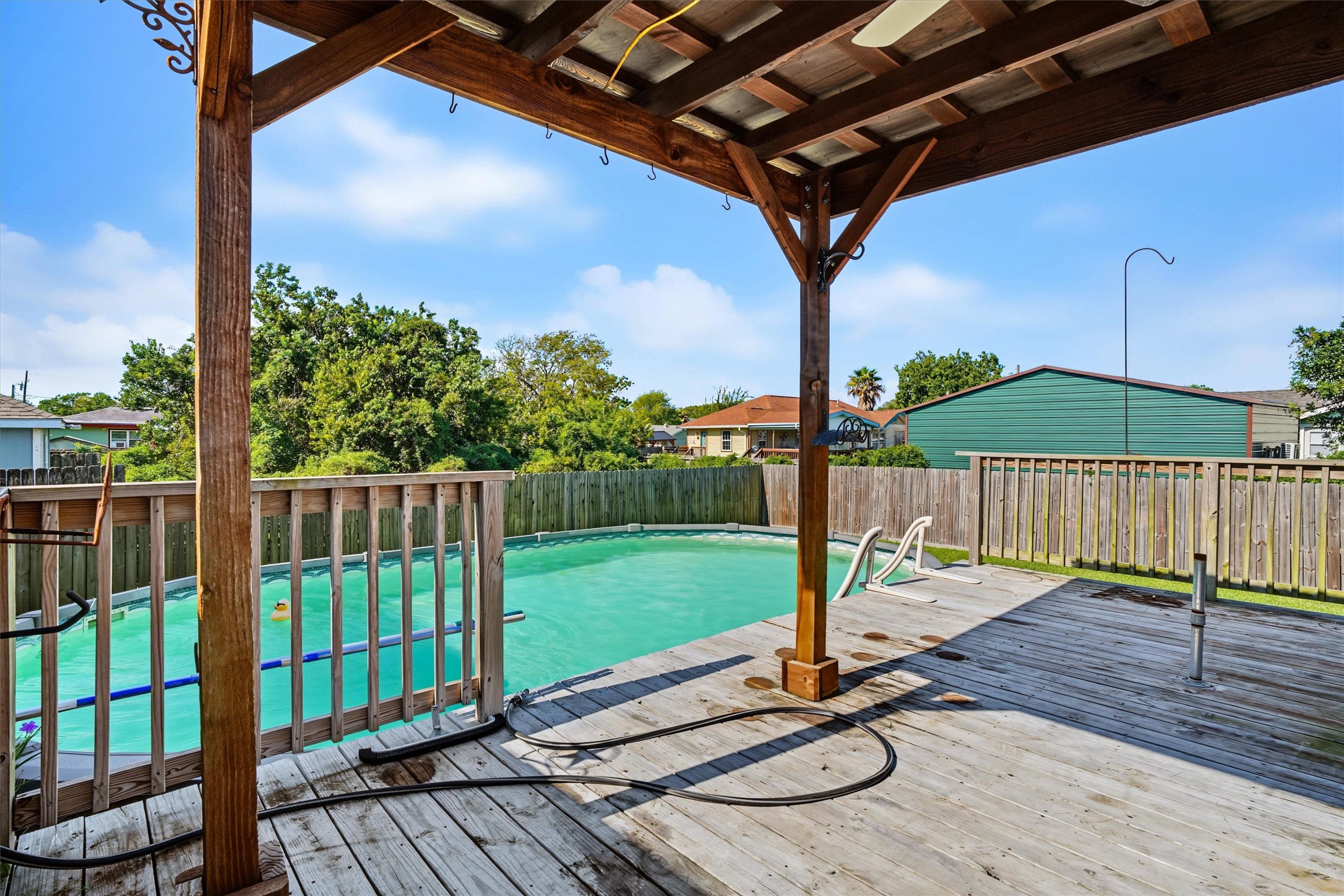 Shaded Poolside Retreat  Relax in the shade while keeping an eye on the kids as they splash and play in the pool. The perfect spot for parents to unwind while the fun continues!