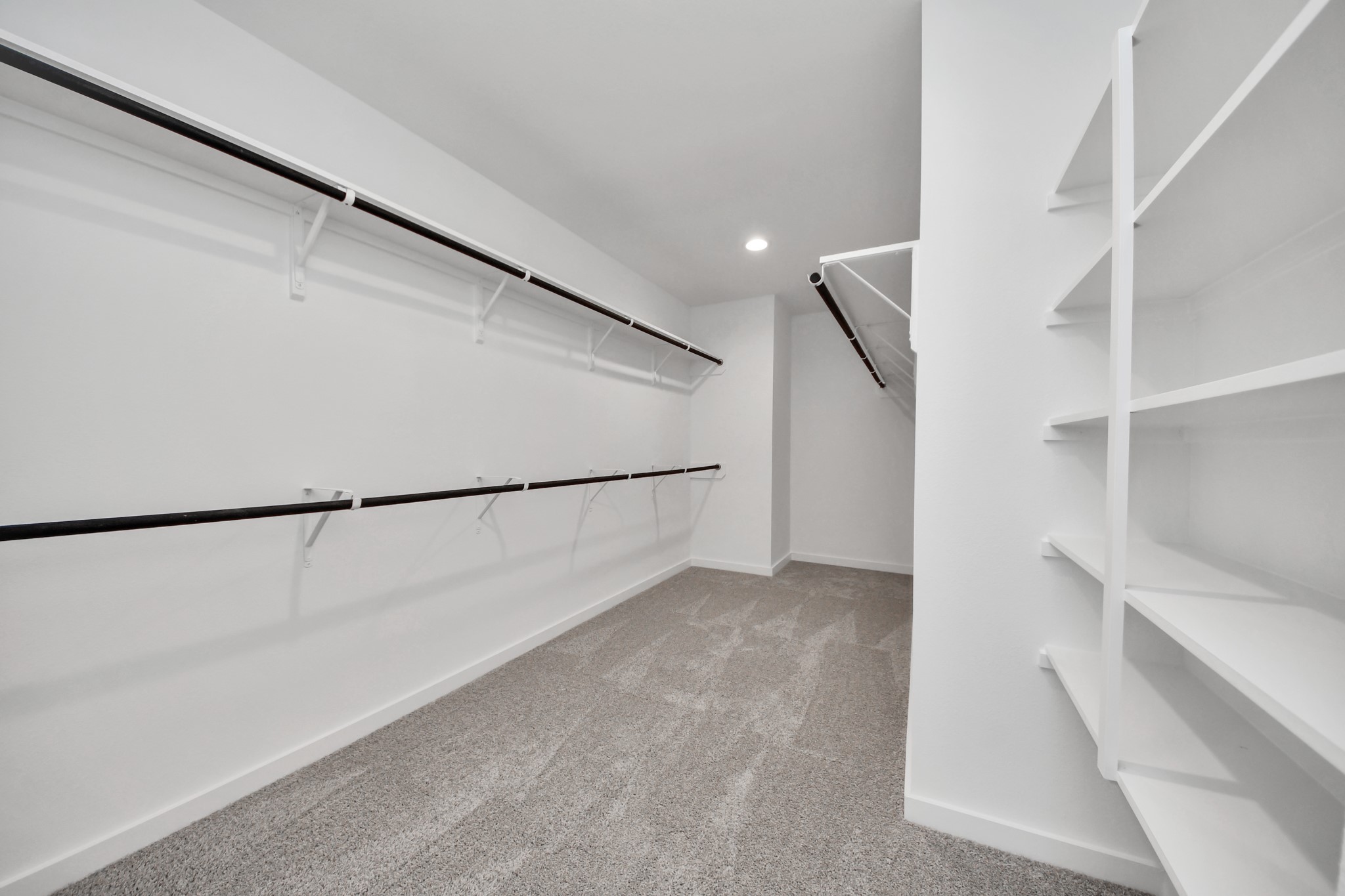 Secondary bedroom features plush carpeting, large windows that let in plenty of natural light, bright paint, and spacious closets. Sample photo of completed home with similar floor plan. Actual colors and selections may vary.