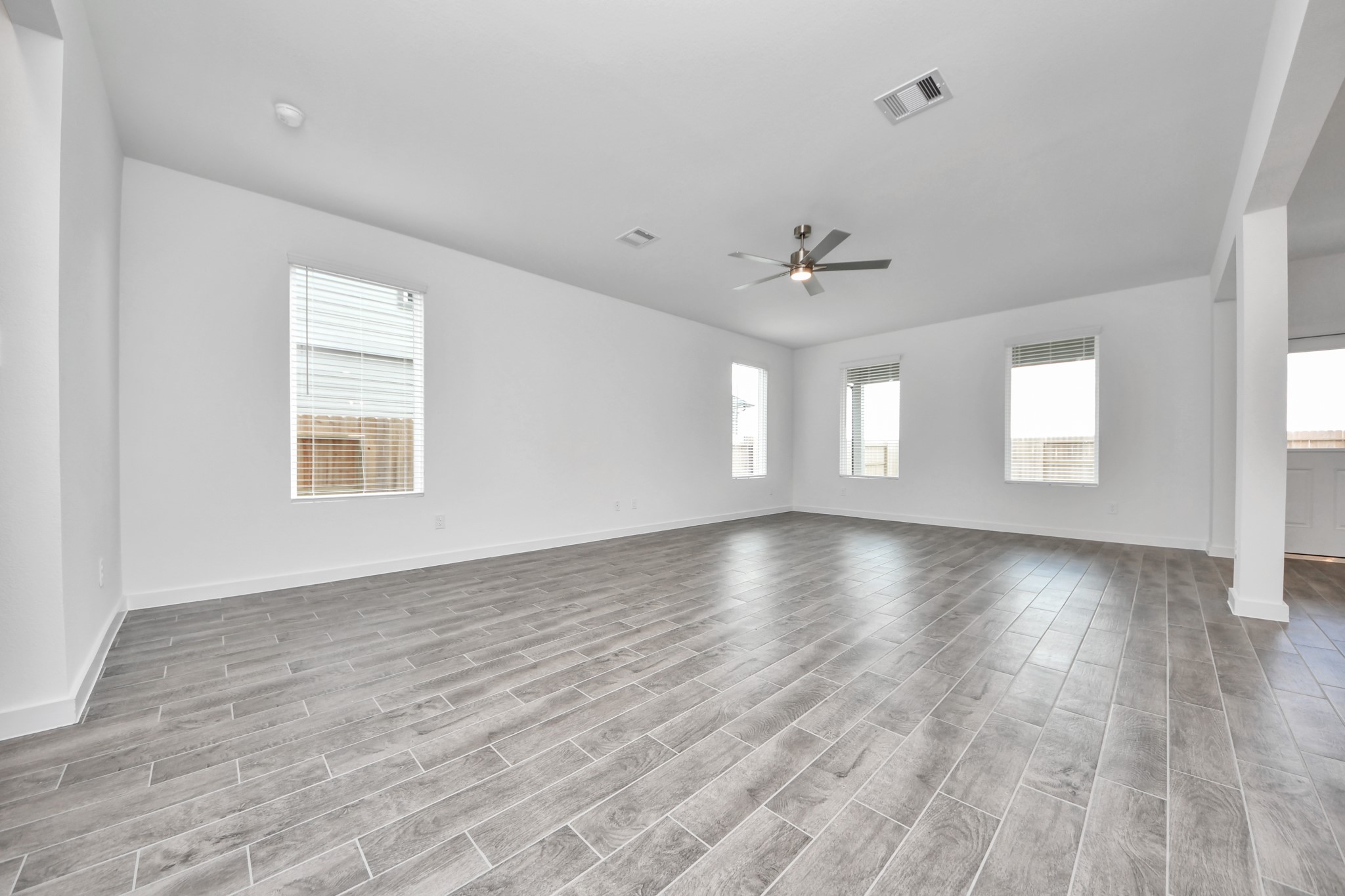Come upstairs and enjoy a day of leisure in this fabulous game room! This is the perfect hangout spot or adult game room! Features plush carpet, high ceilings, custom paint and windows for plenty of natural light. Sample photo of completed home with similar floor plan. Actual colors and selections may vary.