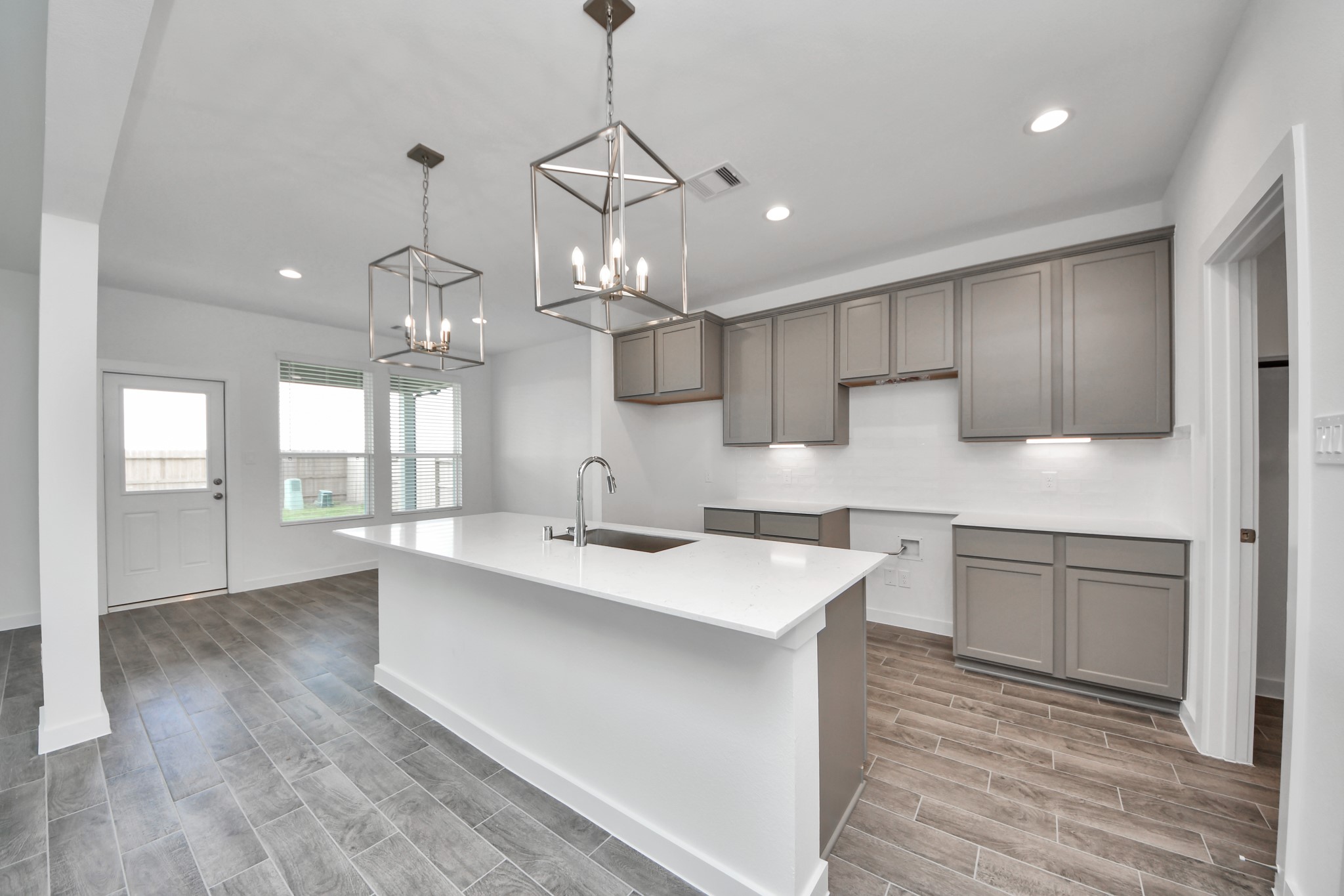 The extended counter area adds both practicality and style, making meal preparation a breeze. Every detail is thoughtfully designed to enhance the kitchen's functionality and aesthetic appeal. Sample photo of completed home with similar floor plan. Actual colors and selections may vary.