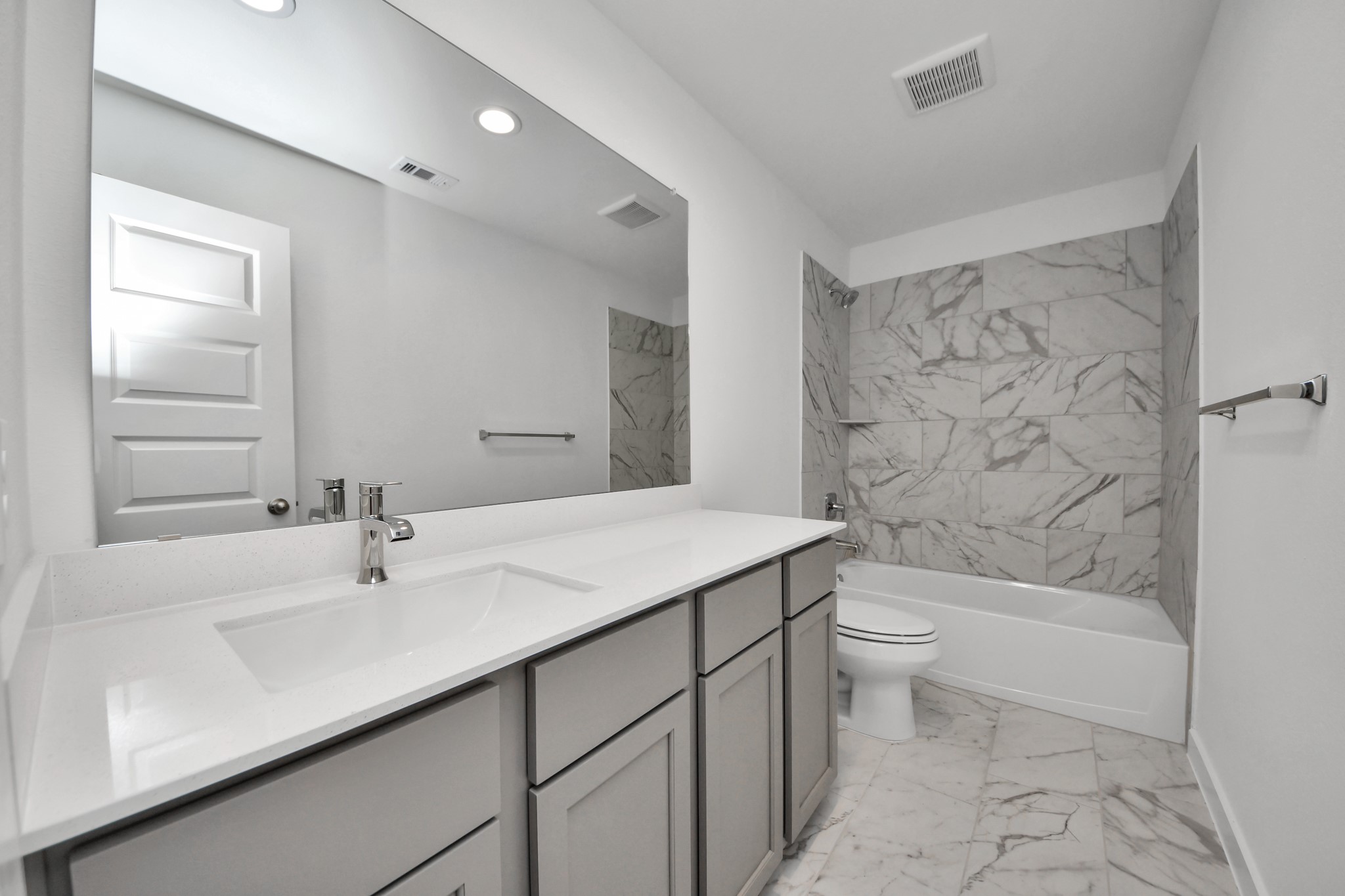 Secondary bedroom features plush carpeting, large windows that let in plenty of natural light, bright paint, and spacious closets. Sample photo of completed home with similar floor plan. Actual colors and selections may vary.