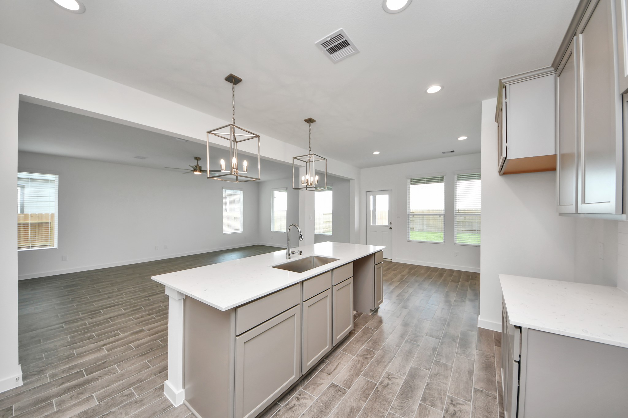 Enjoy breakfast with ease in the connected and cozy breakfast area, seamlessly integrated with the kitchen for utmost convenience. Step through the back door for a breath of fresh air onto the covered patio, extending your living space to the outdoors. Sample photo of completed home with similar floor plan. Actual colors and selections may vary.