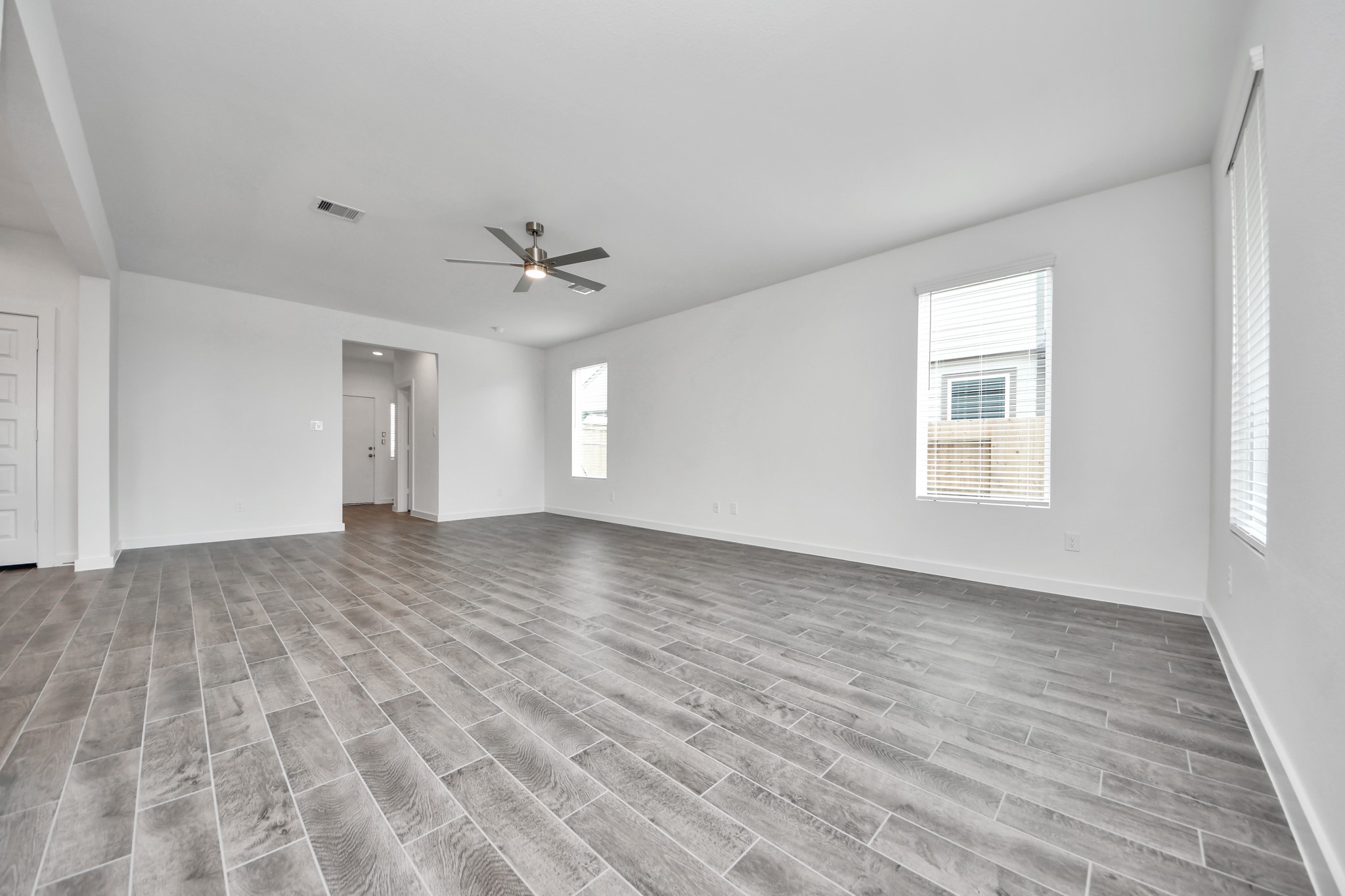 Come and unwind after a long day in this magnificent primary suite! This spacious room features plush carpet, warm paint, high ceilings and large windows with privacy blinds. Sample photo of completed home with similar floor plan. Actual colors and selections may vary.