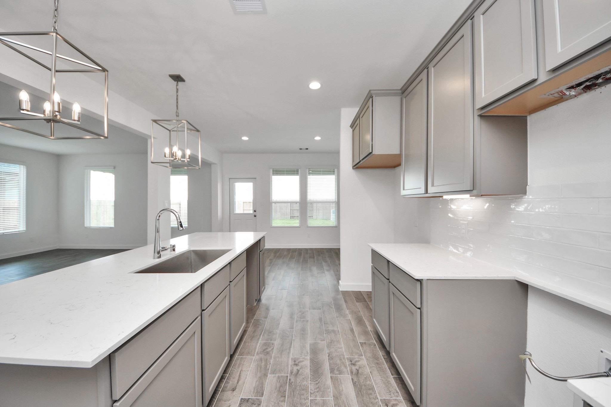 Enjoy breakfast with ease in the connected and cozy breakfast area, seamlessly integrated with the kitchen for utmost convenience. Step through the back door for a breath of fresh air onto the covered patio, extending your living space to the outdoors. Sample photo of completed home with similar floor plan. Actual colors and selections may vary.