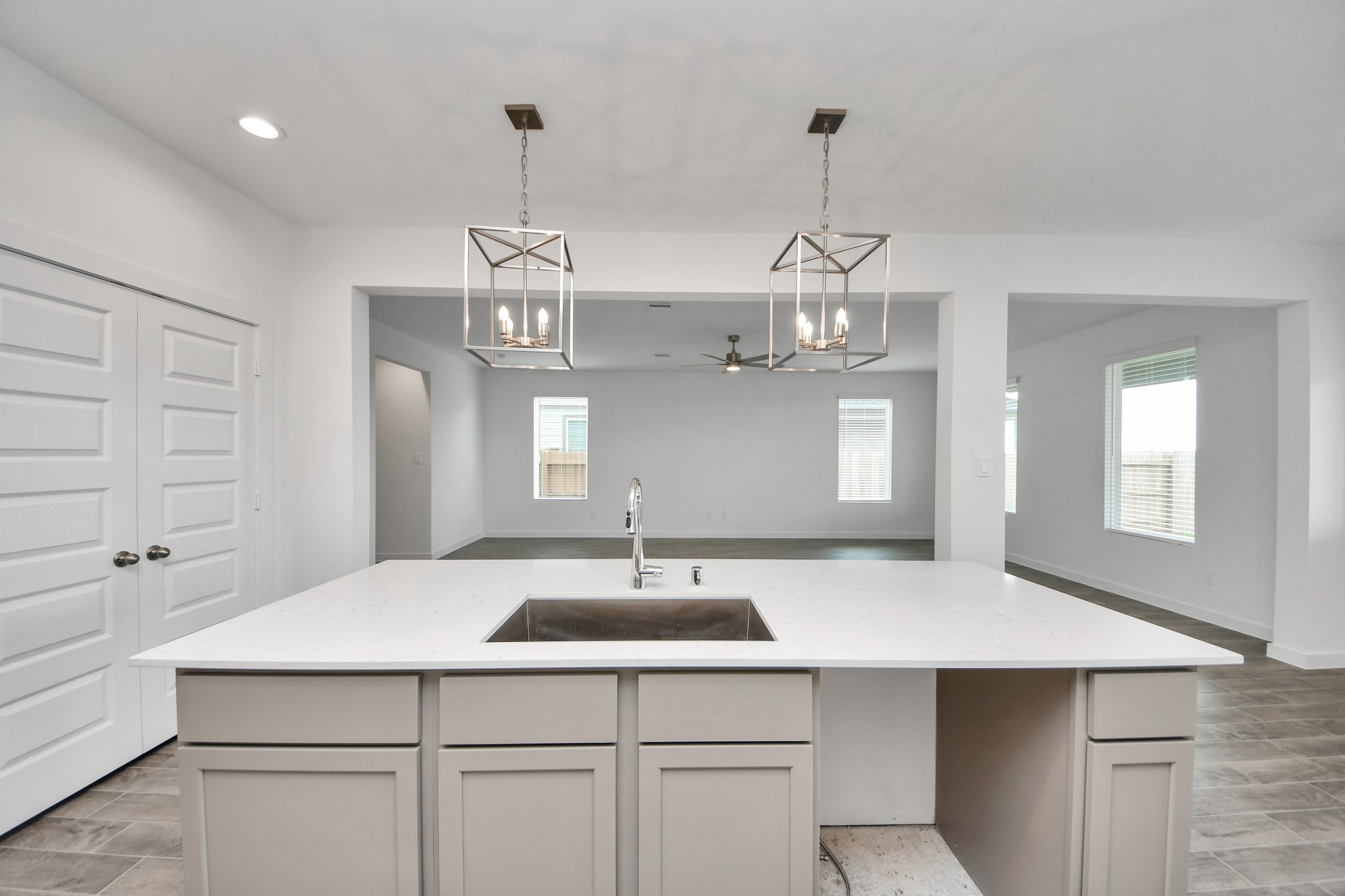 Step into a dream realized with this generously spacious kitchen! A massive granite island takes center stage, complemented by high ceilings and soft-close cabinets. The granite countertops, stainless steel appliances, sleek tile backsplash, and recessed lighting complete the elegant design. Sample photo of completed home with similar floor plan. Actual colors and selections may vary.