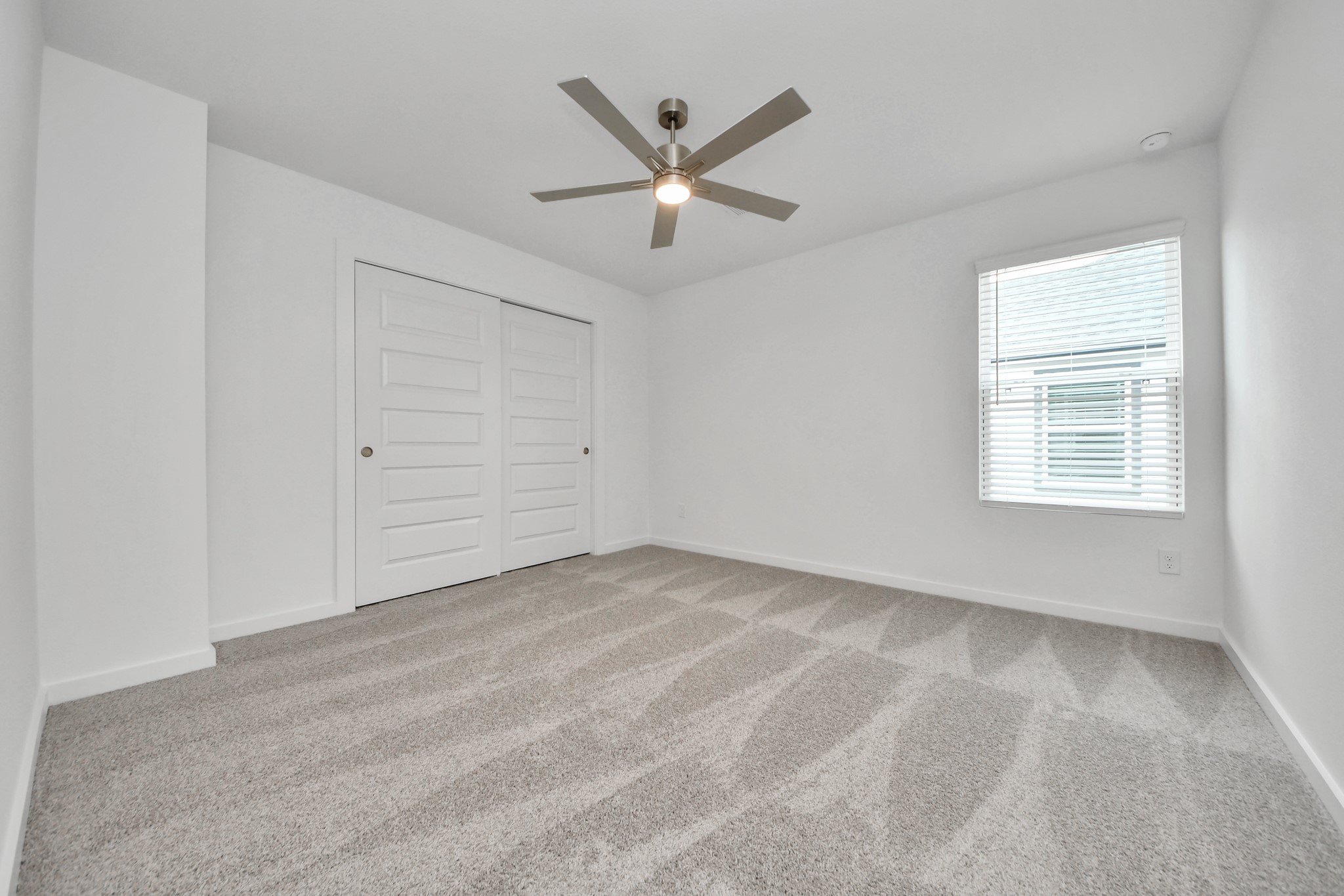 Generously sized secondary bedrooms featuring spacious closets, soft and inviting carpeting underfoot, large windows allowing plenty of natural light, and the added touch of privacy blinds for your personal retreat. Sample photo of completed home with similar floor plan. Actual colors and selections may vary.