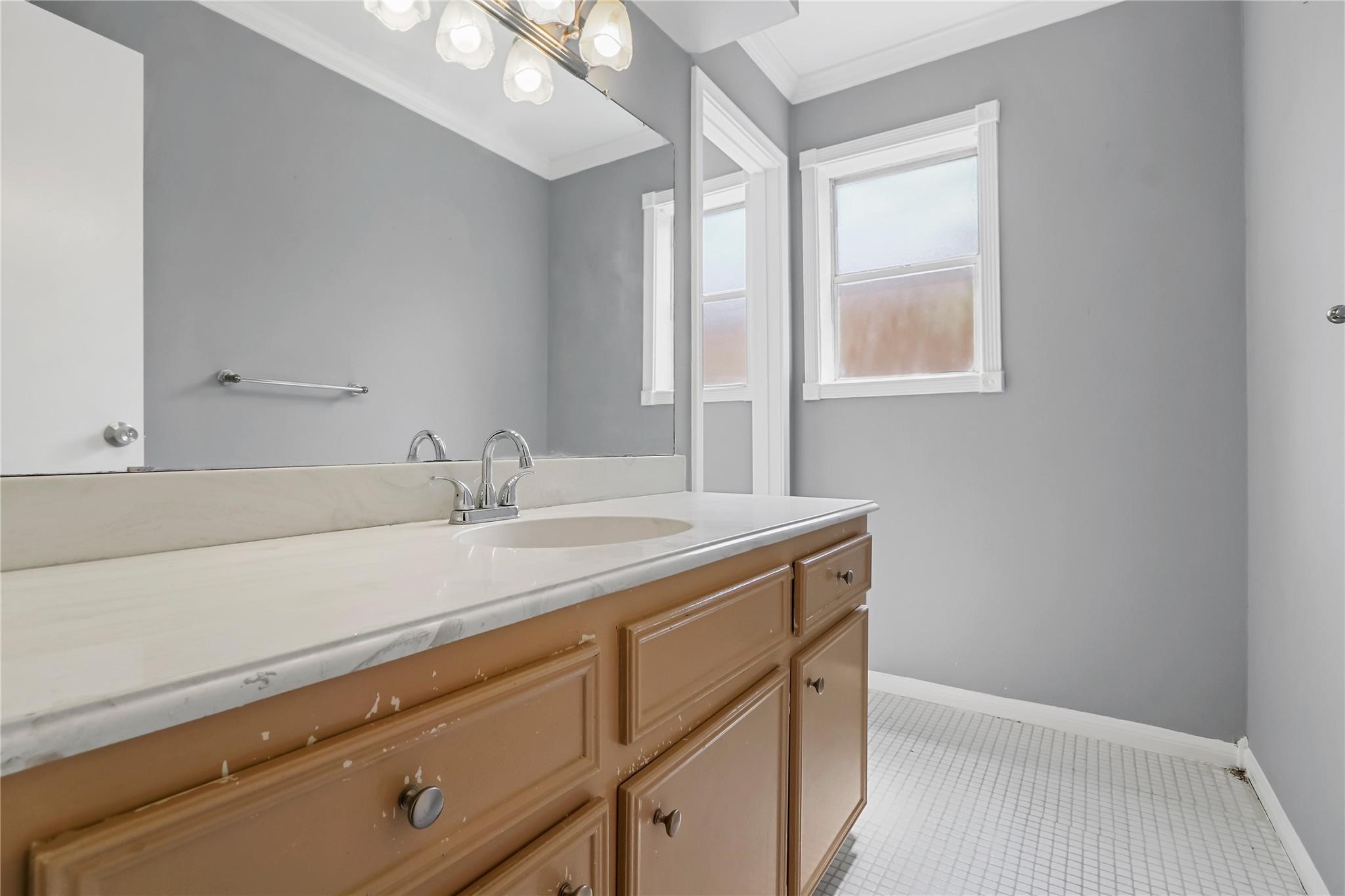 Shared bathroom for secondary bedrooms (vanity has been painted white).