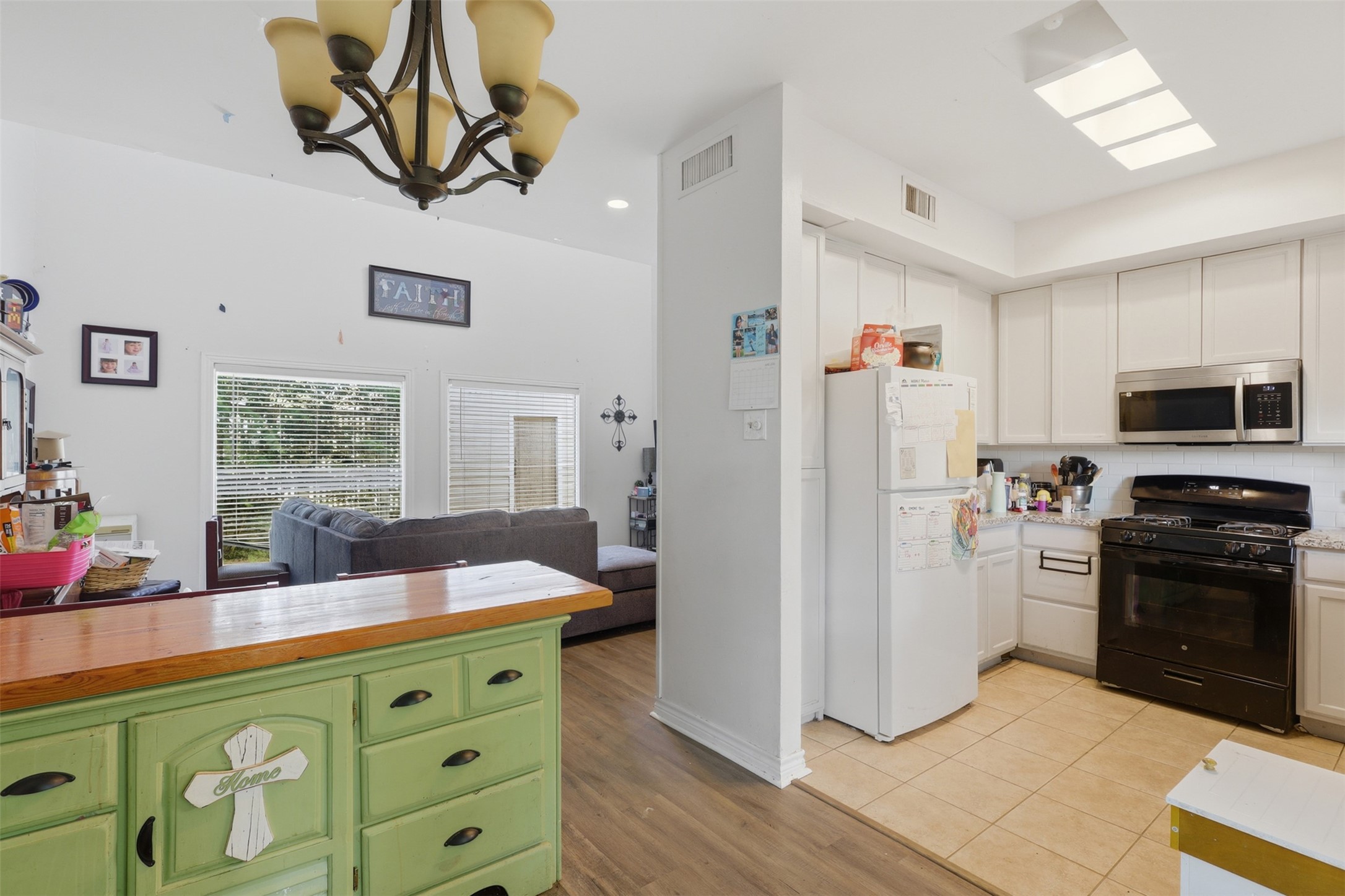 Character-rich breakfast bar provides a natural bridge between the bright functional kitchen and the open living area.