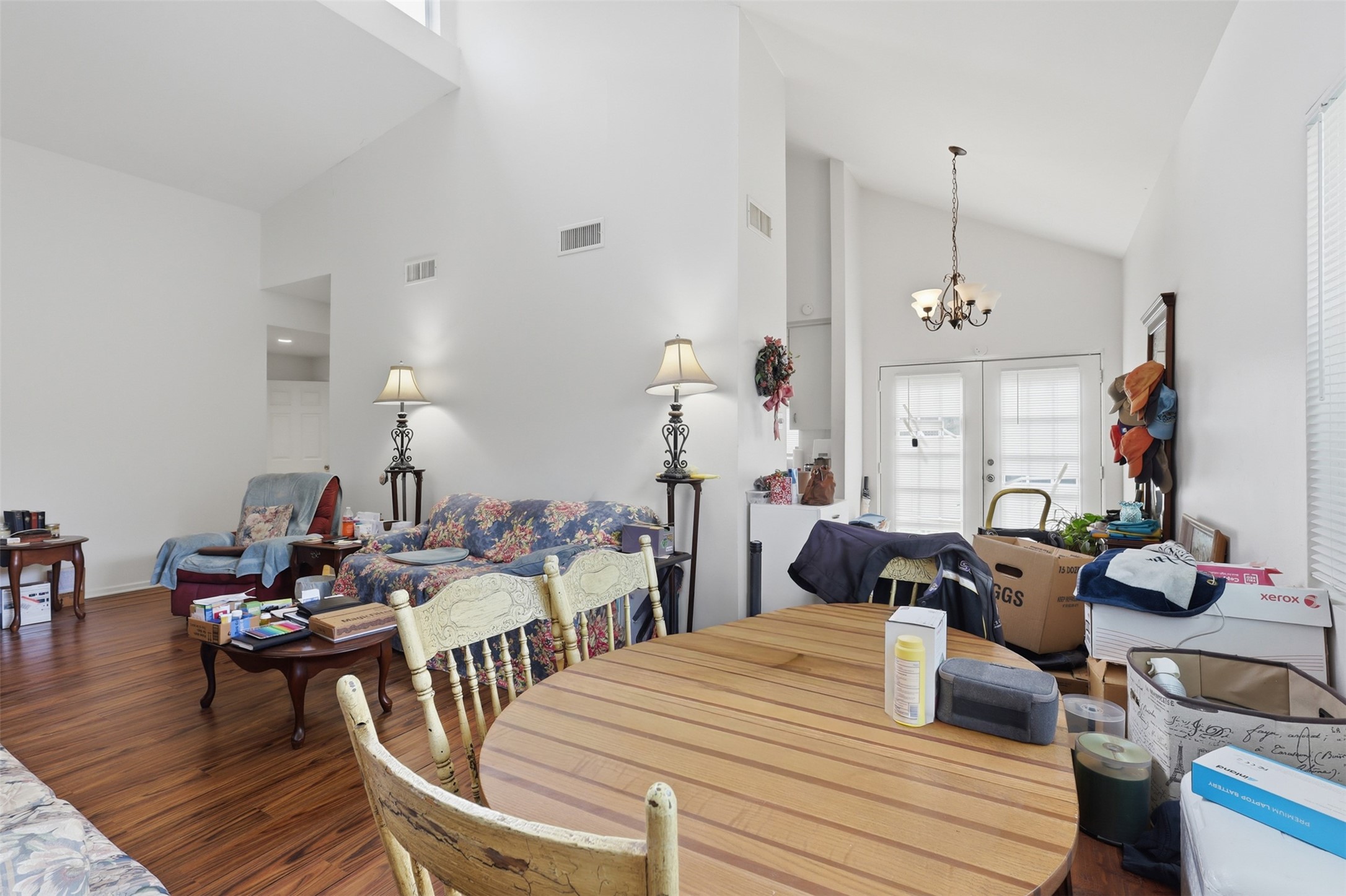Soaring architectural lines and rich wood-plank flooring seamlessly connect the central living space to the light-filled dining area.