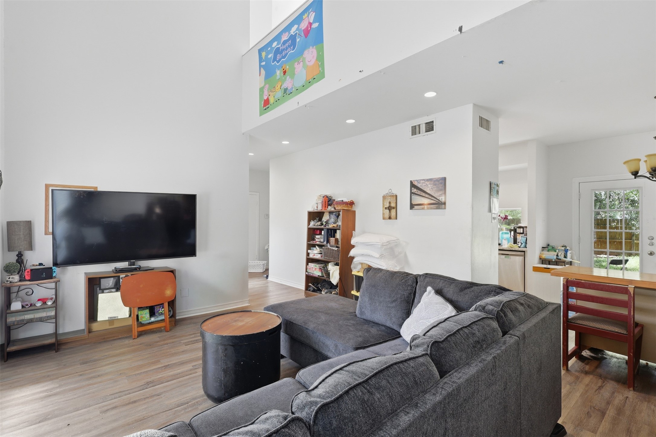A spacious main floor anchor designed for effortless entertaining, seamlessly connecting cozy media seating directly to the kitchen and dining flow.