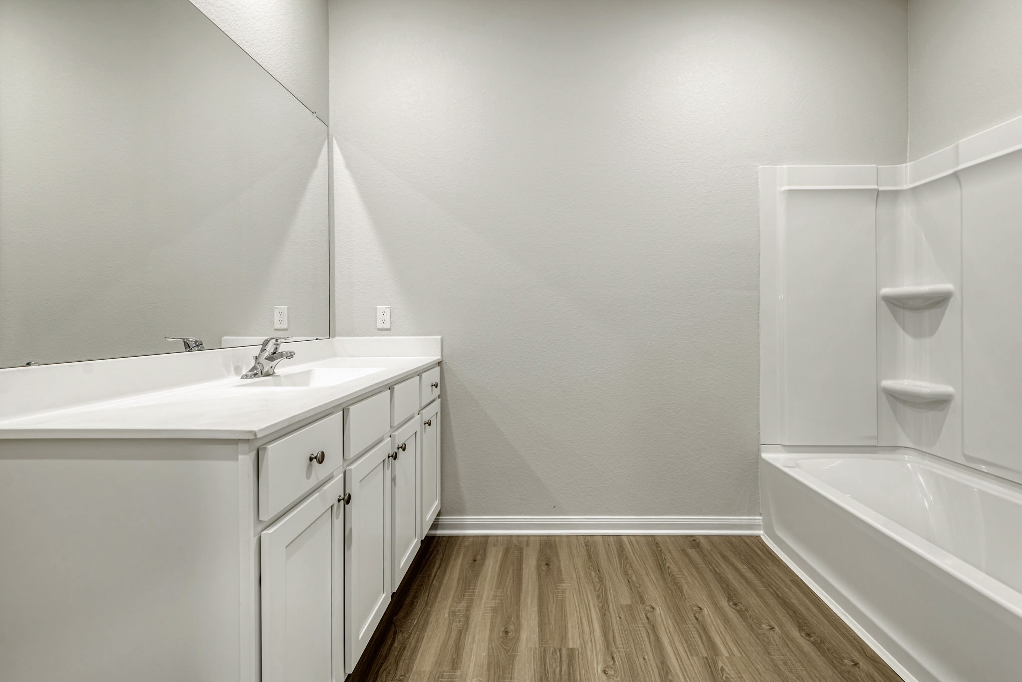 The spacious, primary en-suite bathroom with a shower/tub combo. The spacious, primary en-suite bathroom with a shower/tub combo.