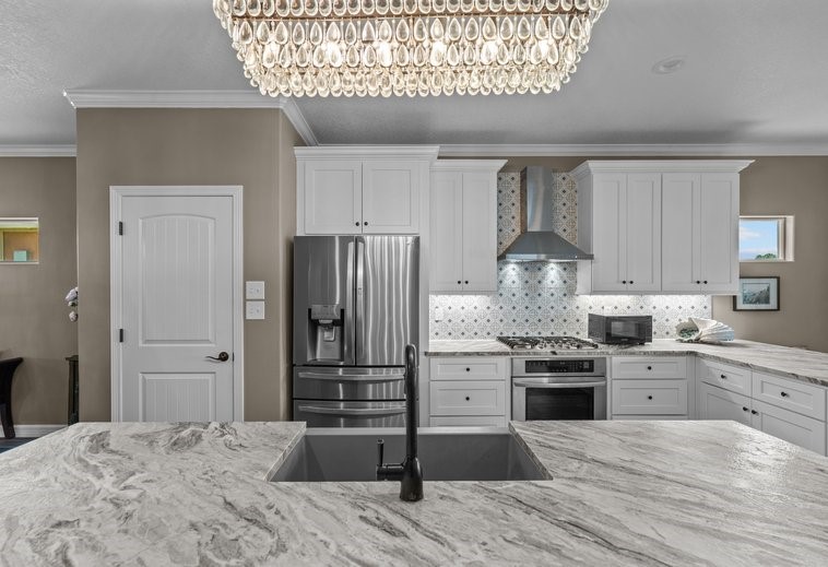 Leathered granite, Solid wood shaker cabinets, walk in pantry, stainless appliances, and a lovely backsplash!