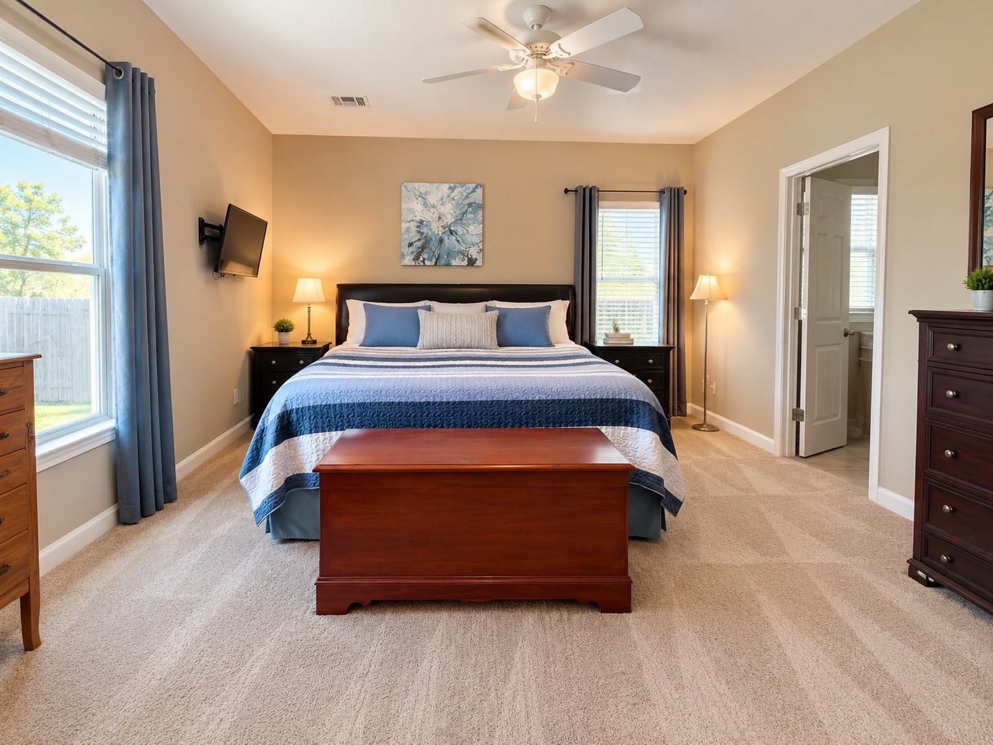 Conveniently located downstairs, the primary bedroom features a spacious en-suite bathroom and generous walk-in closet.