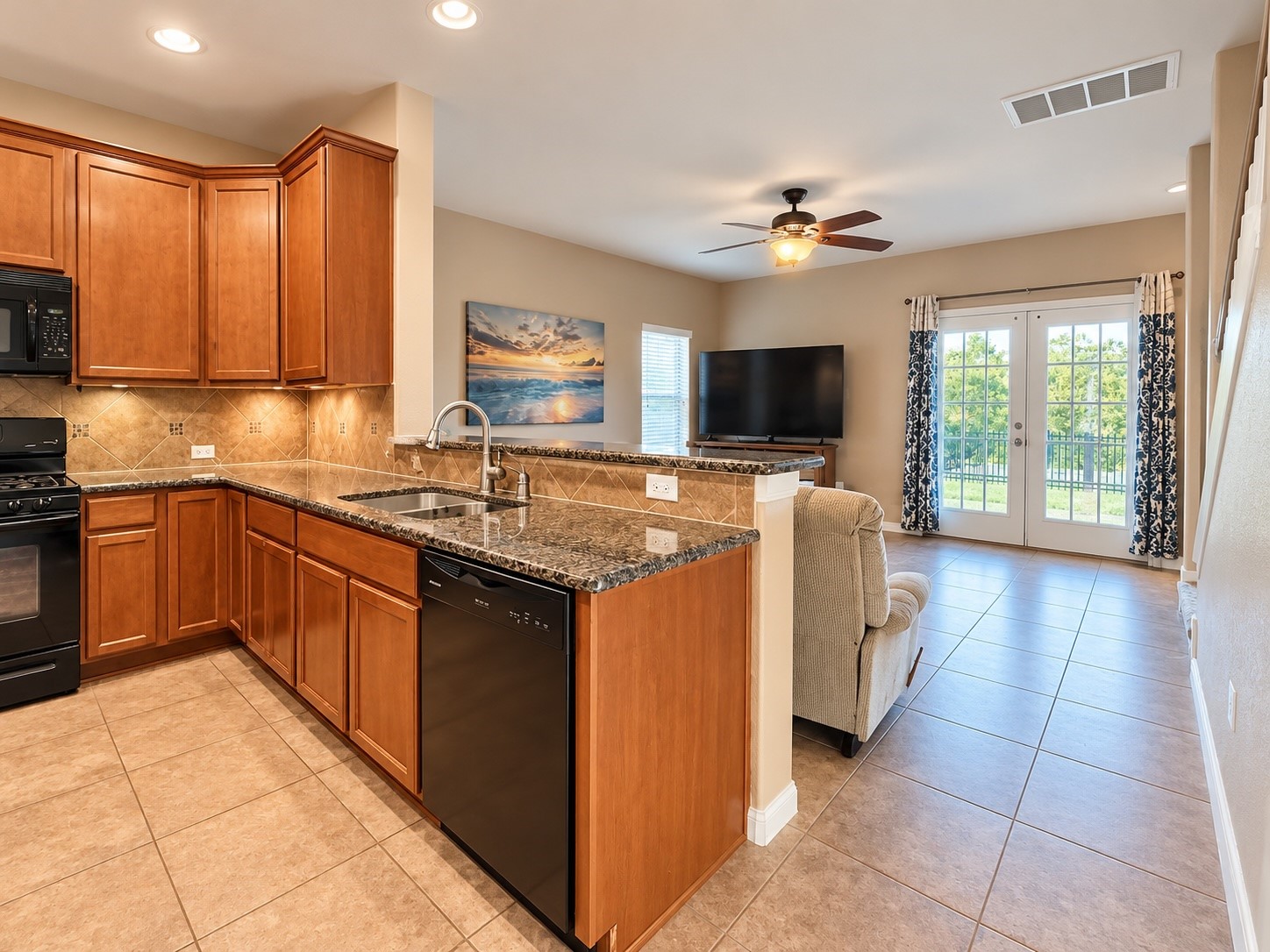 Open kitchen featuring a center island, breakfast bar, granite countertops, and plenty of cabinet space.
