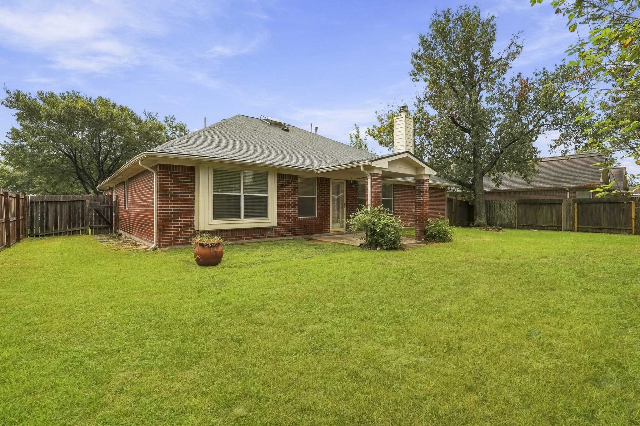 Enjoy a large backyard with a covered patio, perfect for relaxing or entertaining.