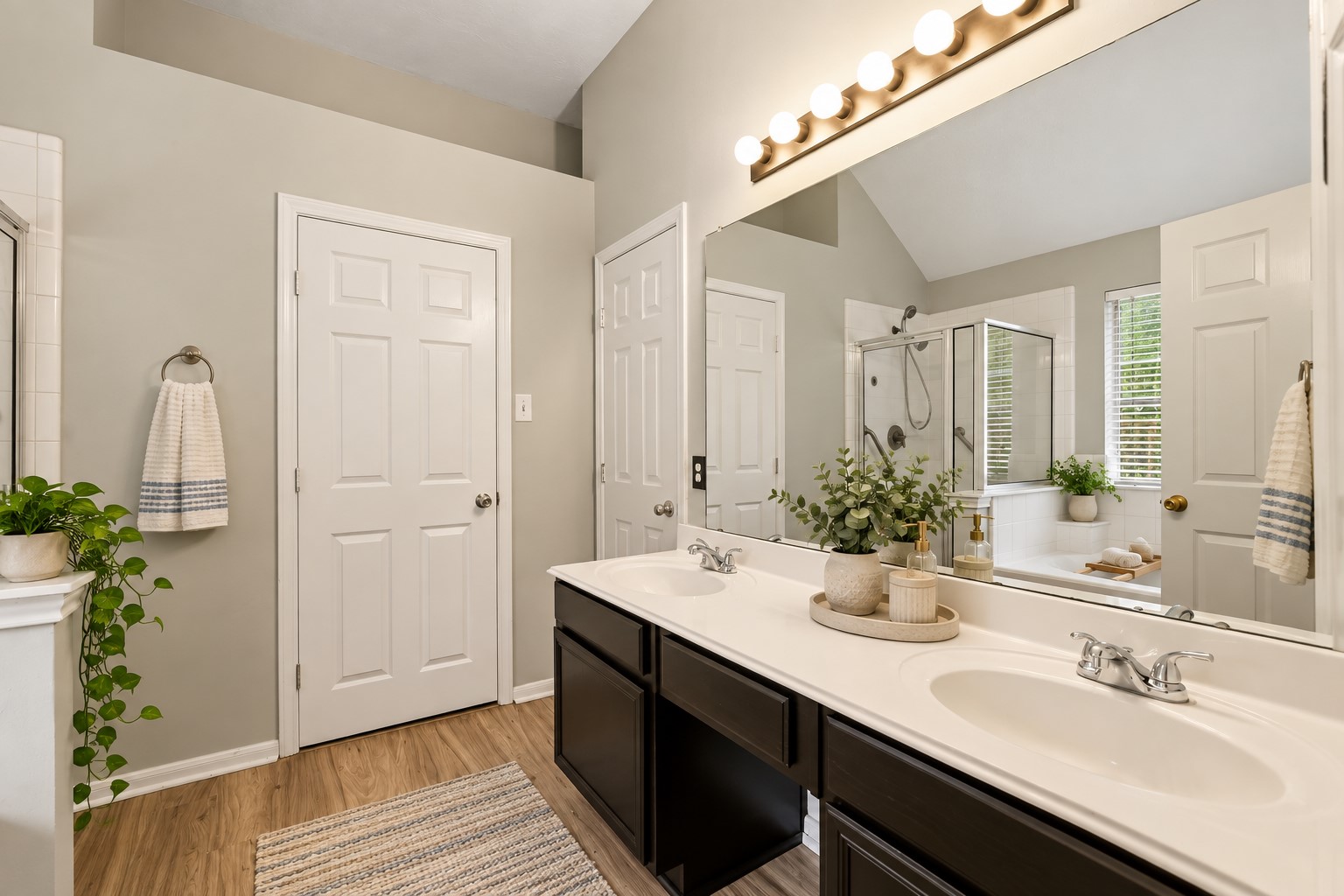 The private primary suite features an en-suite bath with double sinks, soaking tub and separate walk-in shower.