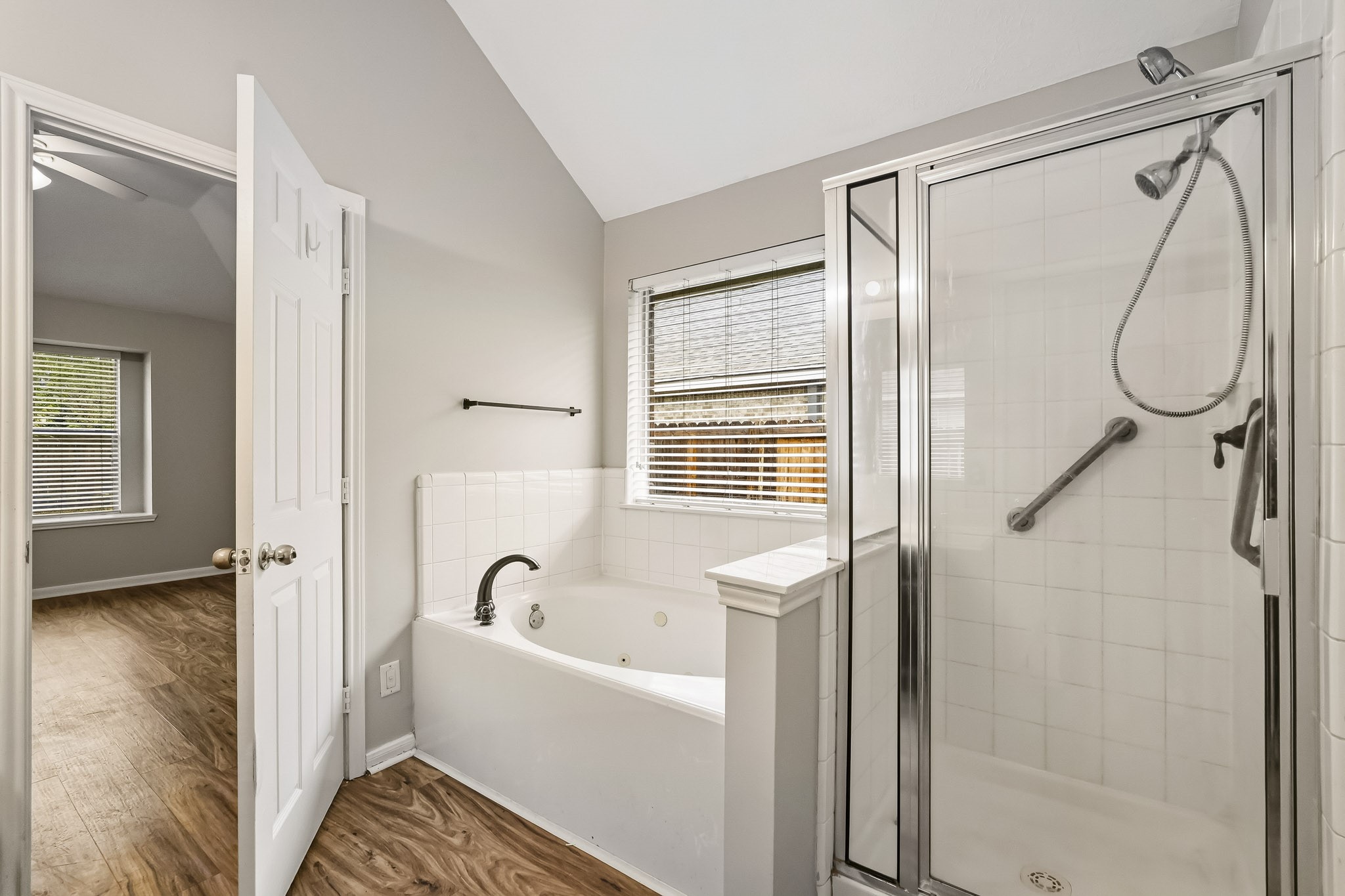 The private primary suite features an en-suite bath with double sinks, soaking tub and separate walk-in shower.
