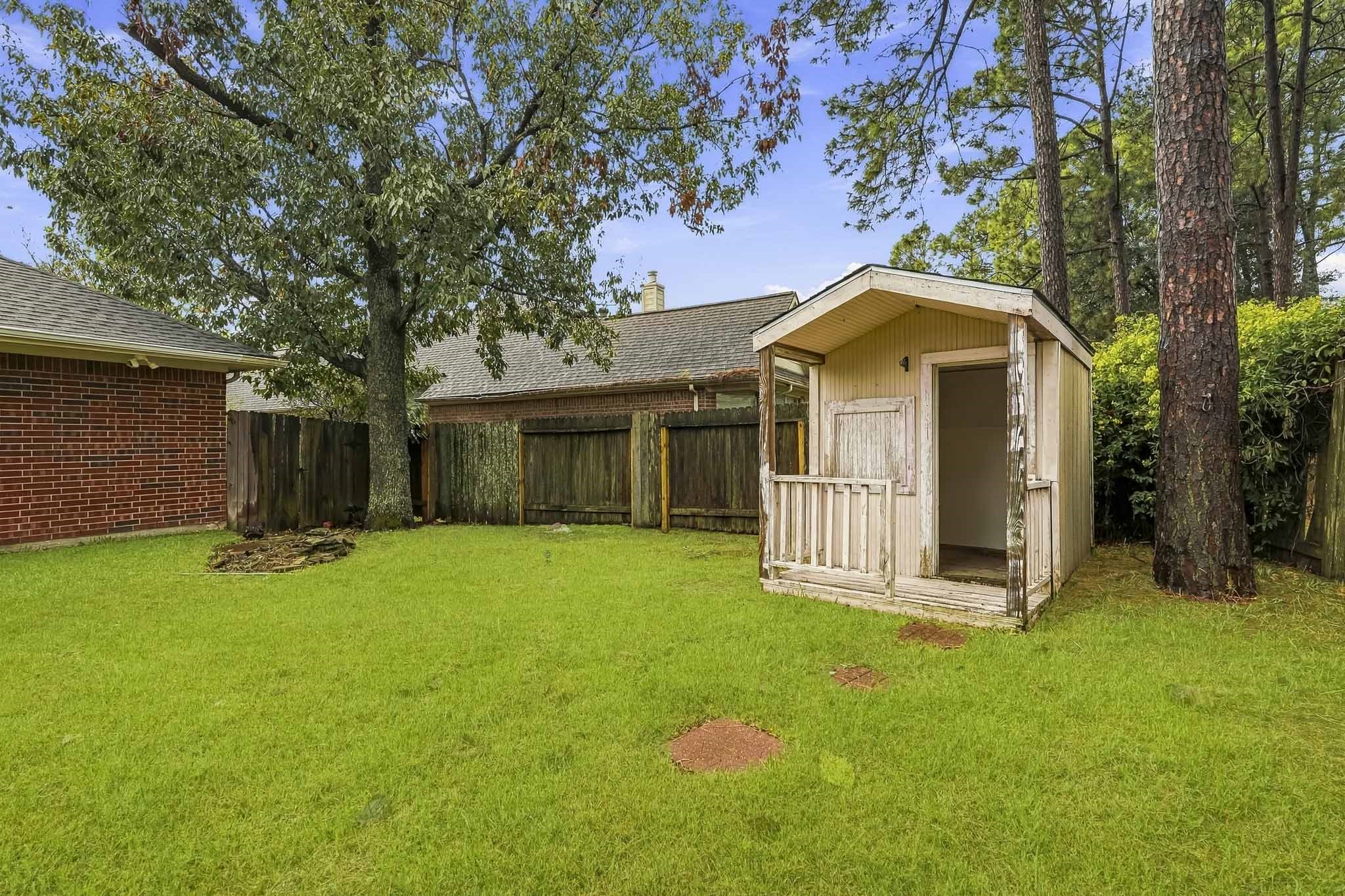 Enjoy a large backyard with a covered patio, perfect for relaxing or entertaining.