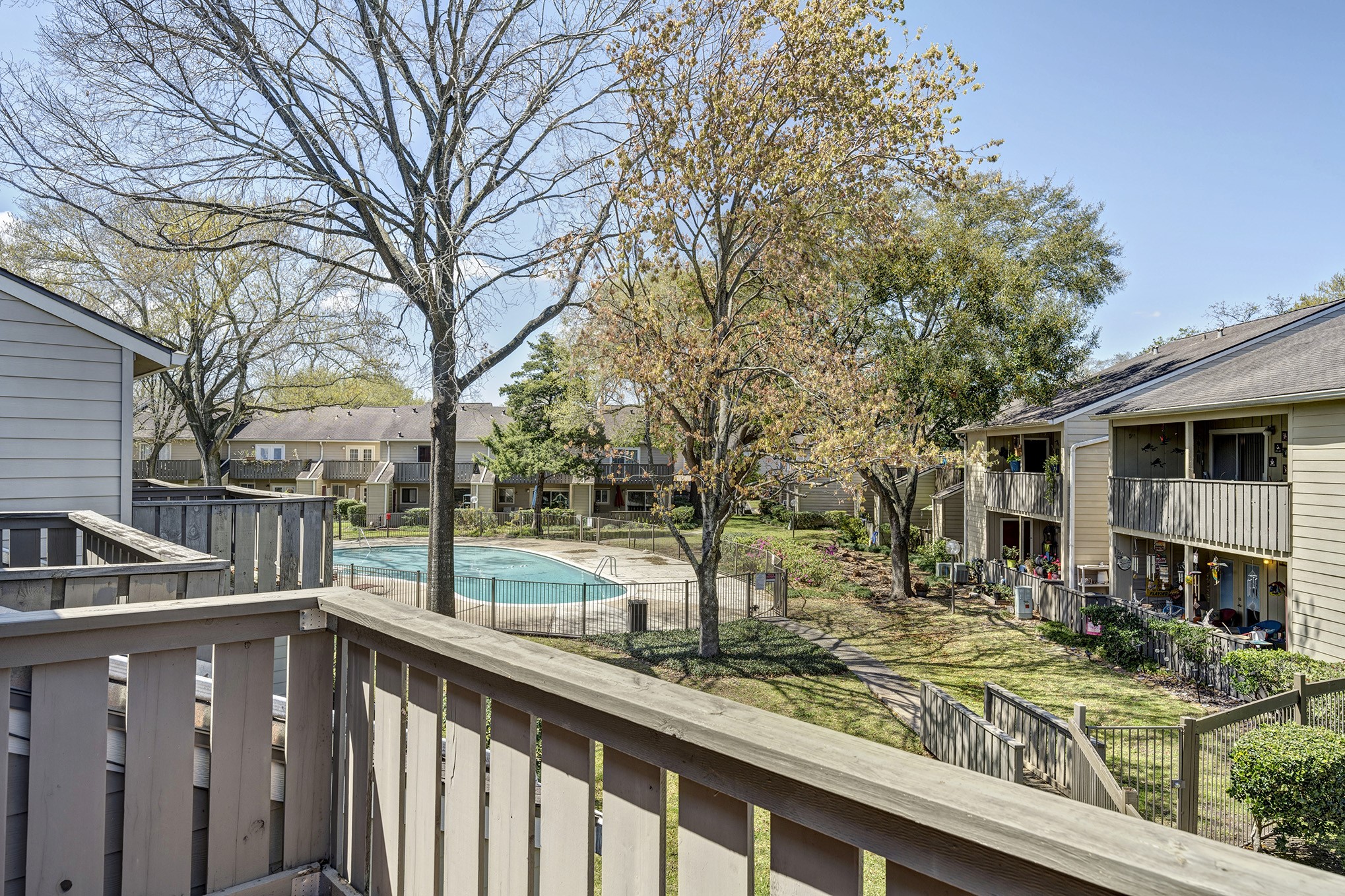 Upstairs balcony off the back bedroom overlooks the interior grounds and nearby pool.