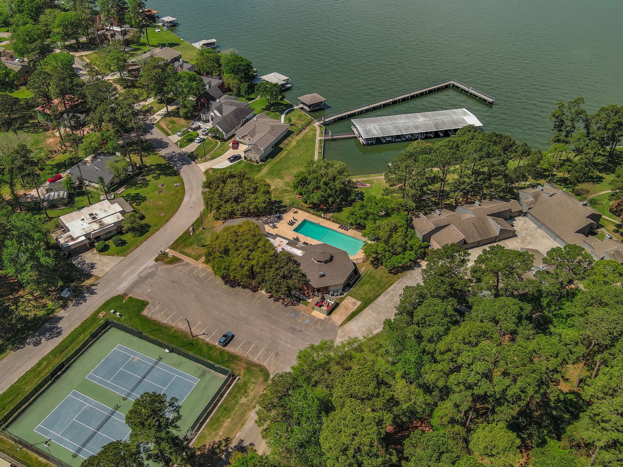 View of the tennis courts, community pool, fishing pier and boat slips.
