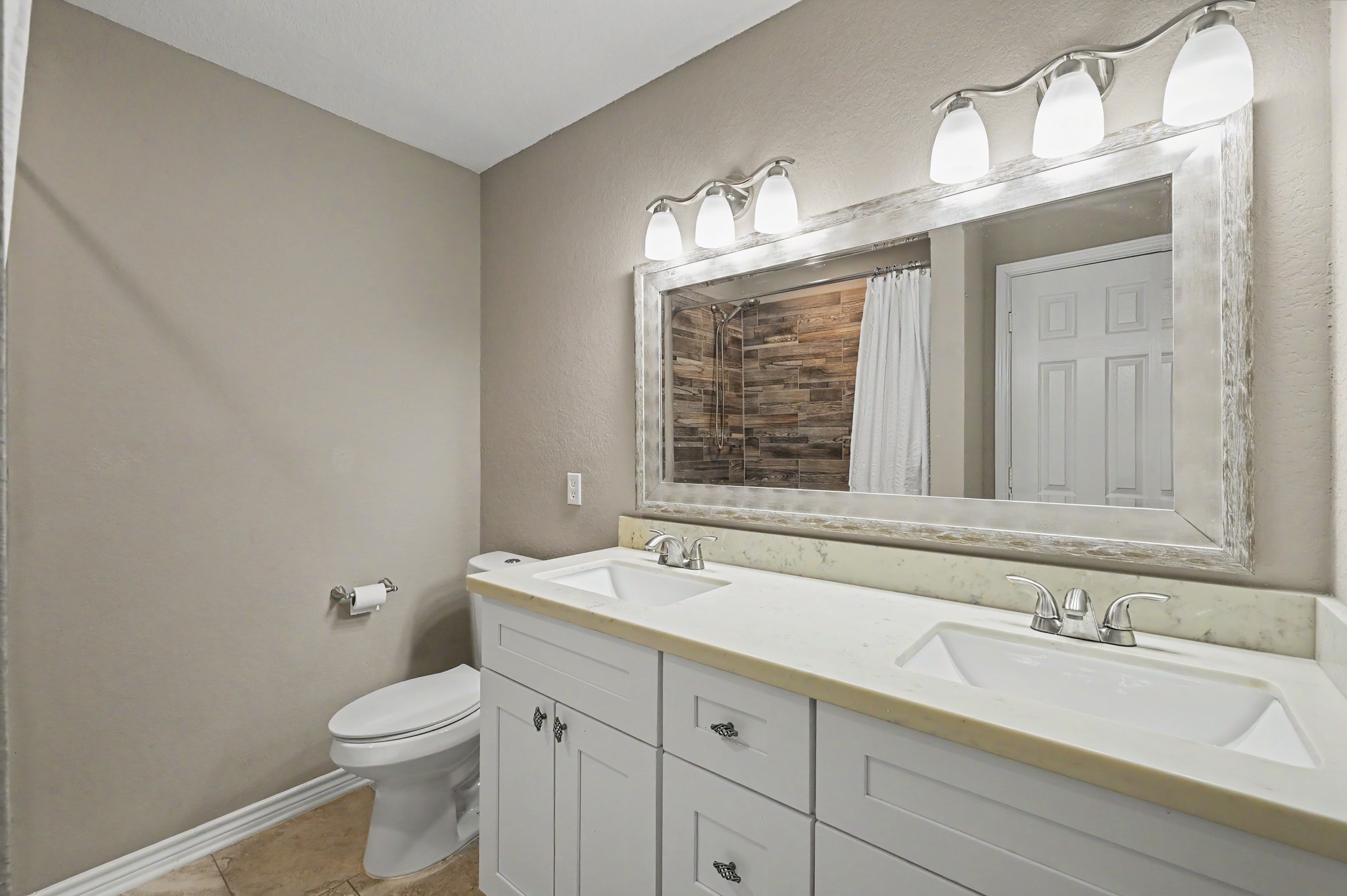 Bedrooms 3 and 4 share the 3rd full bath with dual sinks.