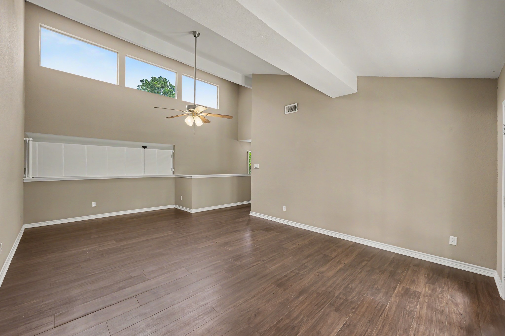 Sellers recently had the beautiful Clerestory windows tinted to reduce heat while allowing natural light to continue to fill the space. Retractable mesh safety curtain shown across the loft overlook.