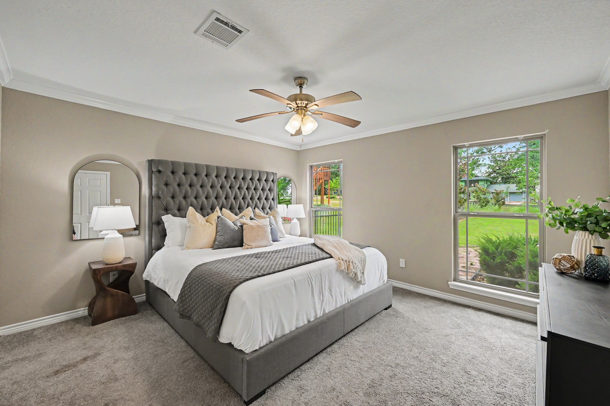 First floor primary retreat with nearly floor to ceiling windows.