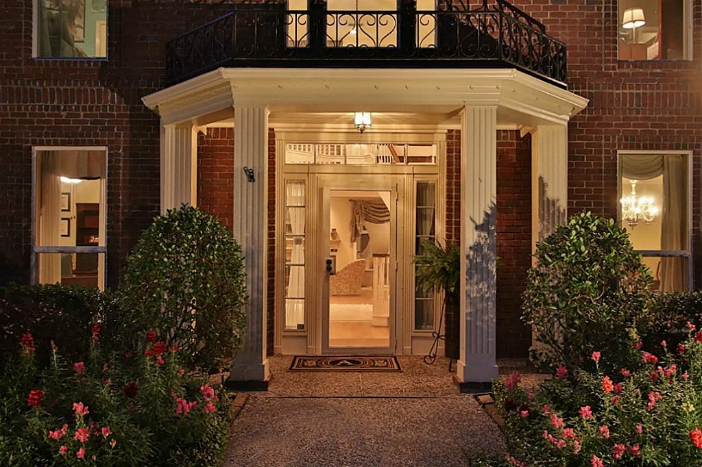FRONT ENTRANCE WITH CLASSIC FLUTED COLUMNS & IRON TRELLIS. As you enter the home, notice the grand architecture that Don Hand is so well known for.