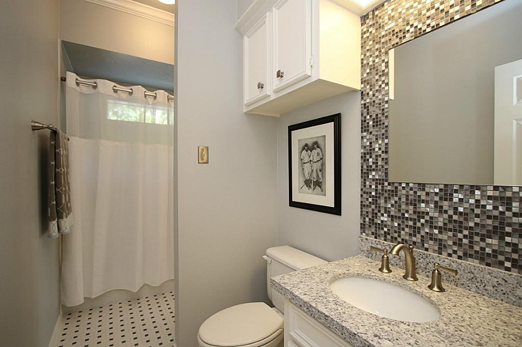 SECOND FULL BATHROOM UPSTAIRS NICELY REMODELED All bathrooms have been tastefully remodeled with neutral granite vanities, new sinks, faucets and tile flooring. This bathroom has a tiled mirror wall for an added design feature.