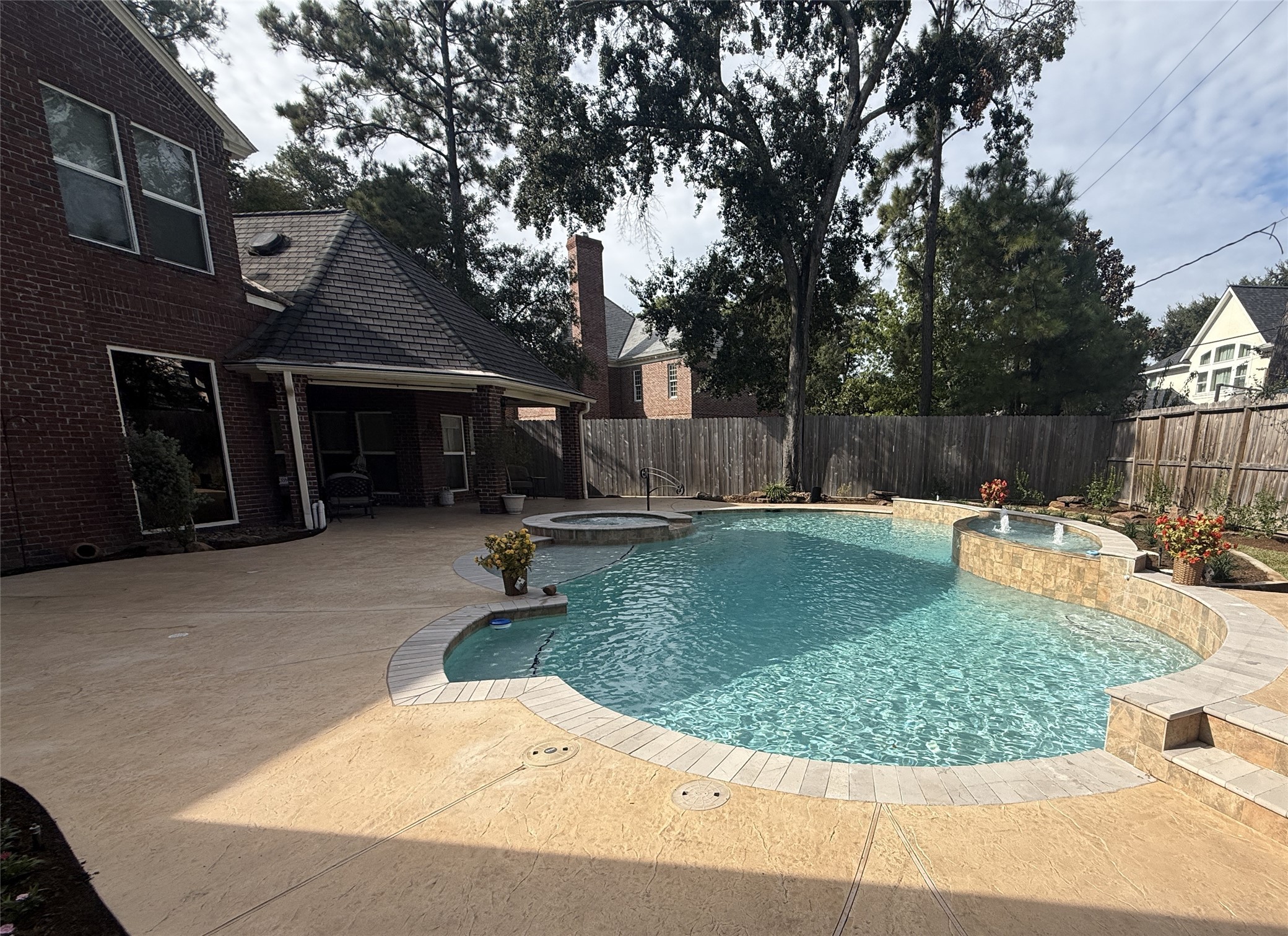 REMODELED POOL WITH STAMPED CONCRETE PATIO