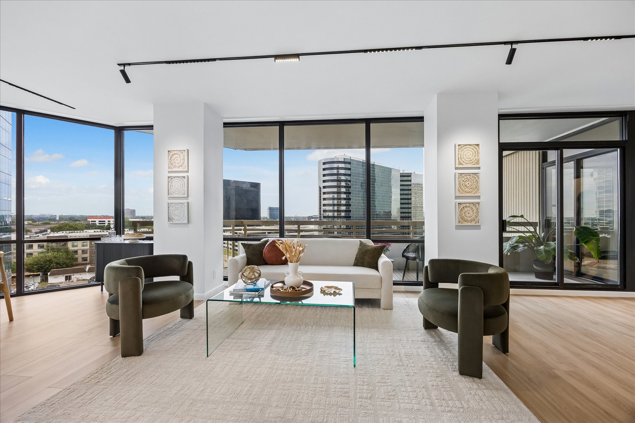 Broad windows frame city views beside direct access to the covered balcony. Broad windows frame city views beside direct access to the covered balcony.