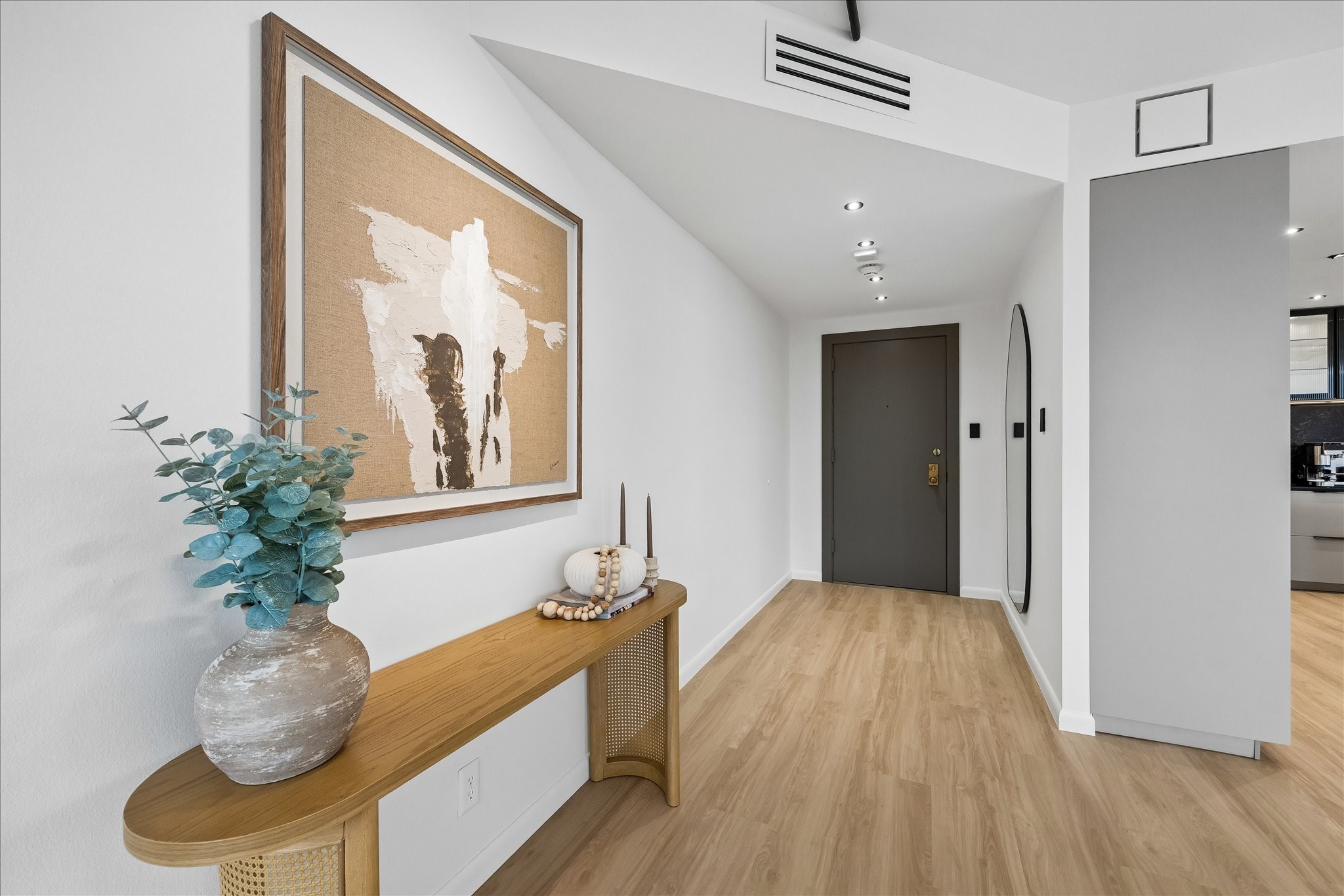 App control manages lighting throughout the home, including the entry and open living areas.