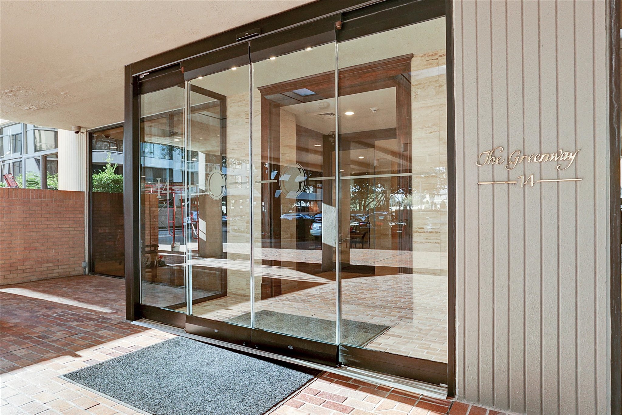 Welcome to 14 Greenway Plaza. A covered entrance and glass doors create an inviting arrival, complemented by the buildings concierge and valet services.