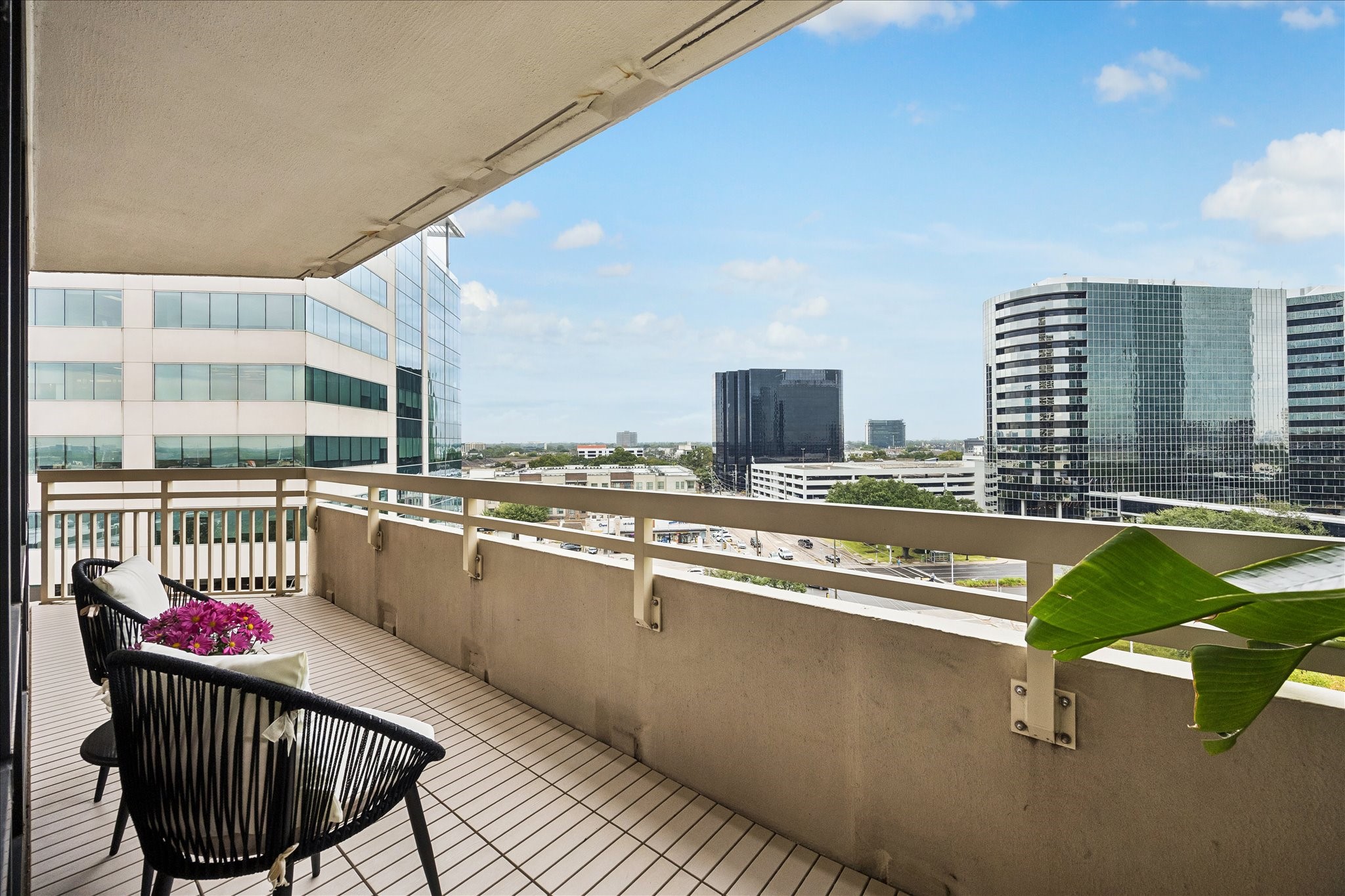 Covered balcony provides an outdoor extension of the living space with city views. Covered balcony provides an outdoor extension of the living space with city views.