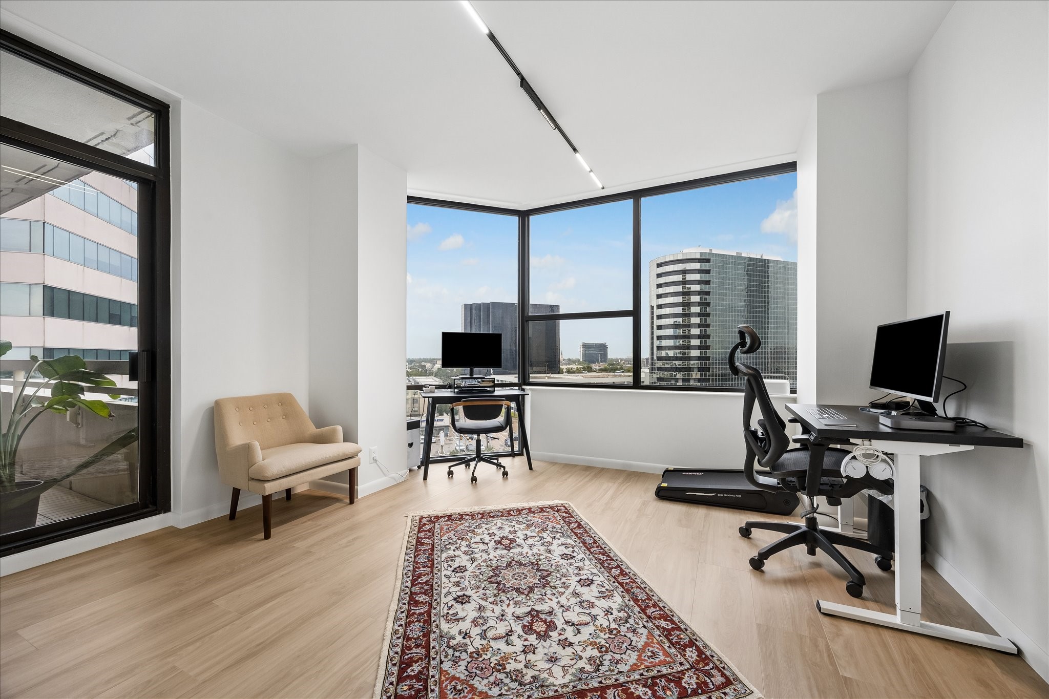 Corner windows and direct balcony access give this bedroom flexibility for a study.